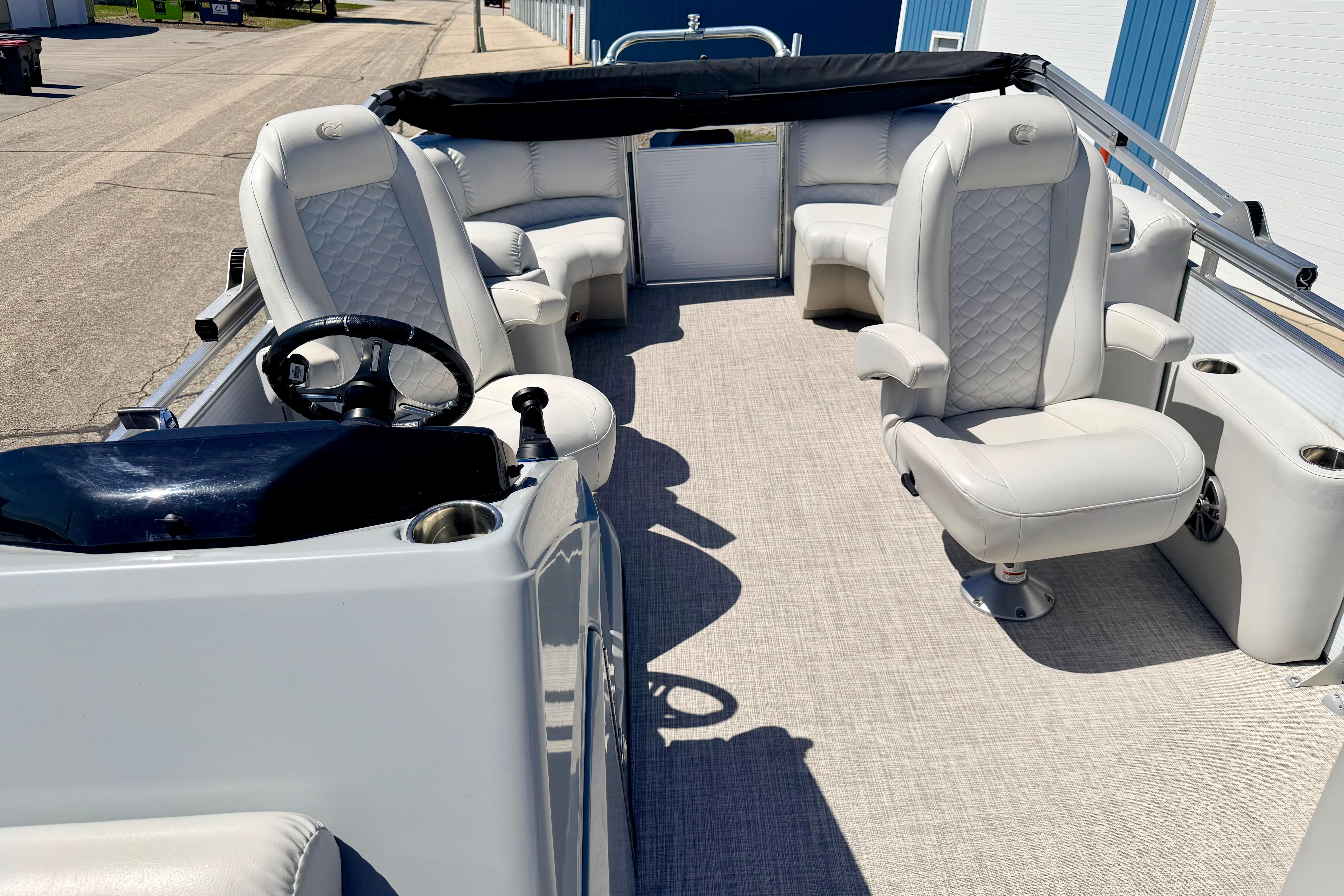 2019 Crestliner 240 Rally DX CW pontoon boat interior with plush seating and steering console.