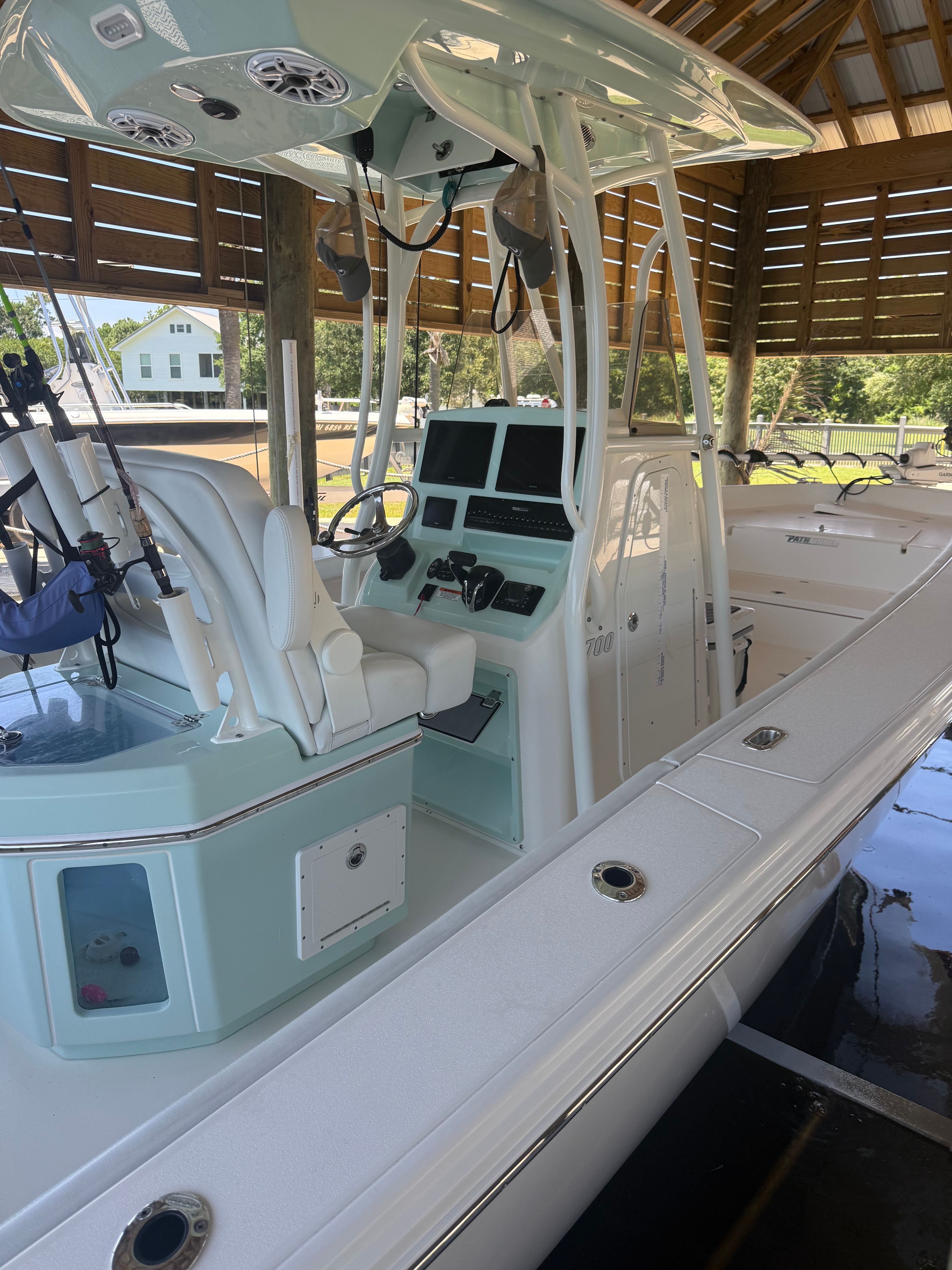 2024 Pathfinder 2700 Open boat docked under shelter.