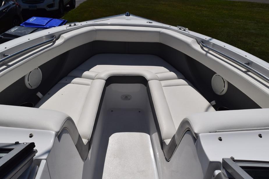 2006 Cobalt 240 boat interior with white cushioned seating and stainless steel railings.