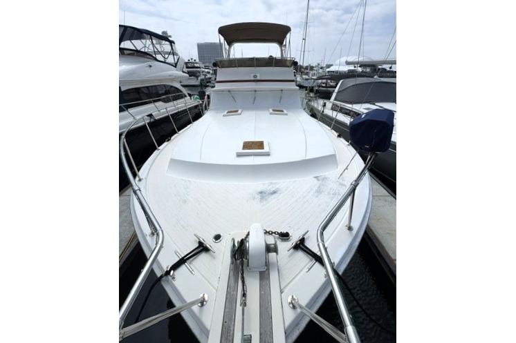 1980 Viking 43 Convertible yacht docked at marina, showcasing spacious deck and sleek design.