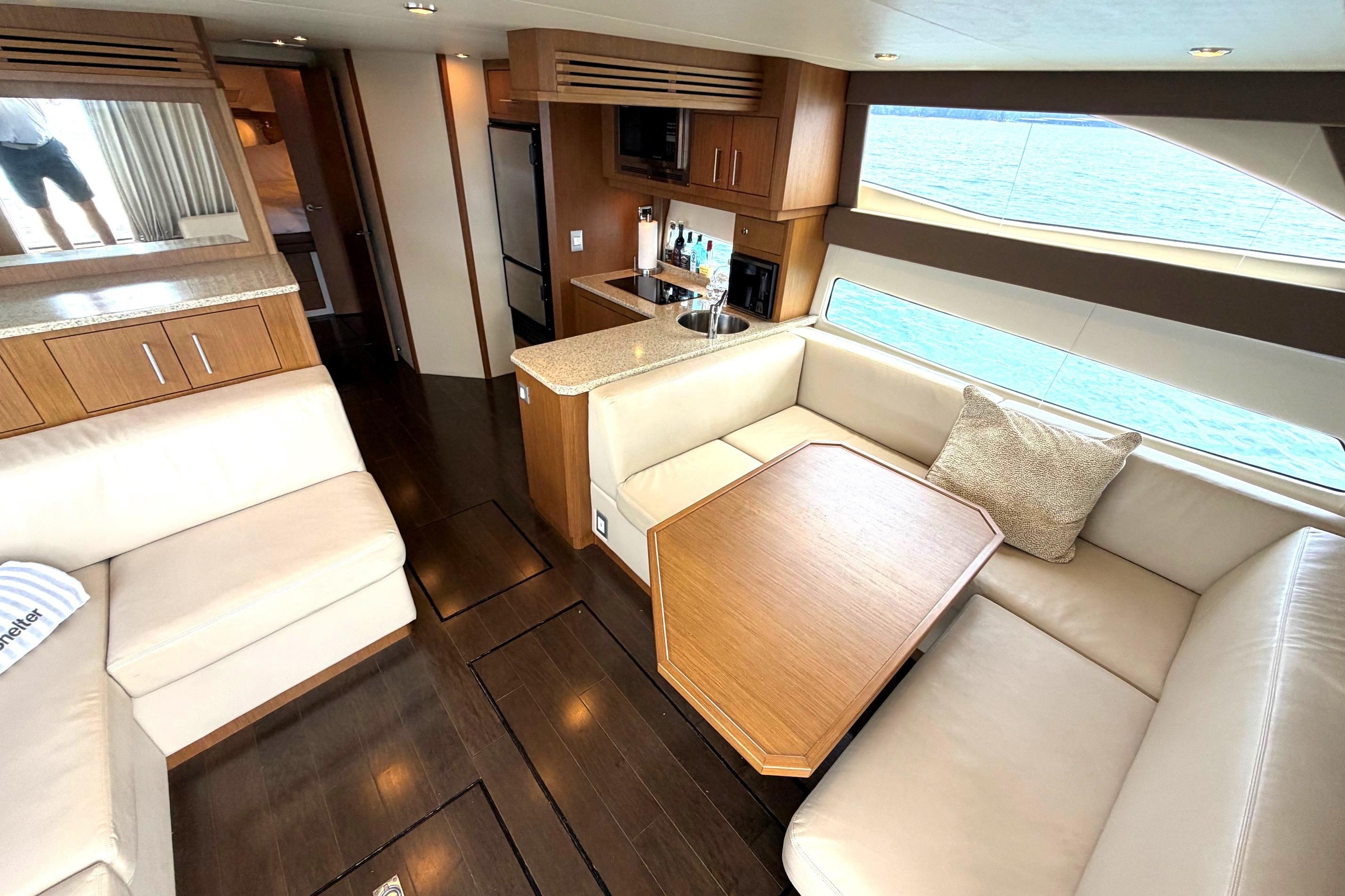 Luxurious interior of 2011 Carver 44 Sojourn yacht with elegant seating and dining area.