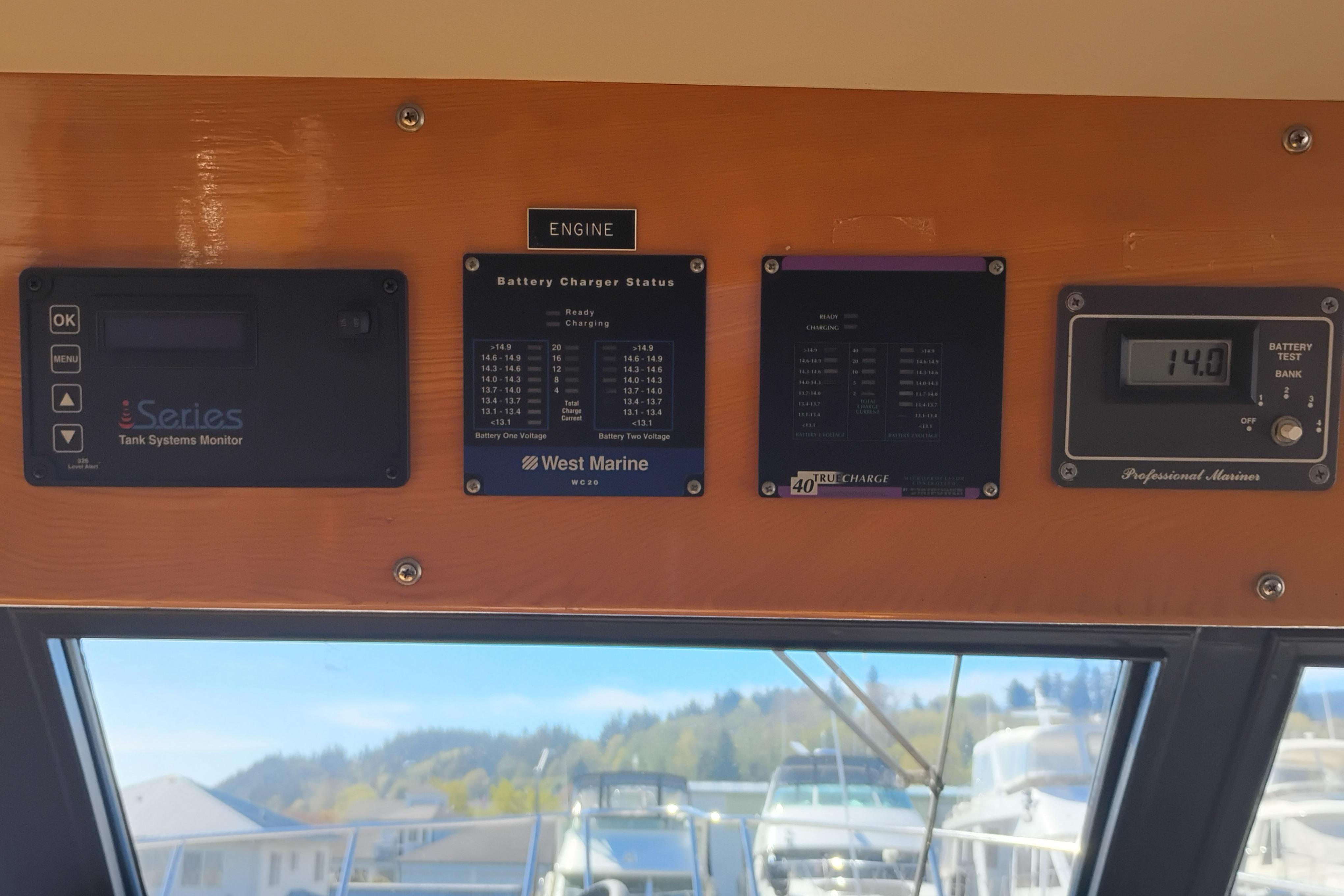 Control panel of a 1988 PT 52 AFT Cabin Motor Yacht with battery monitors.