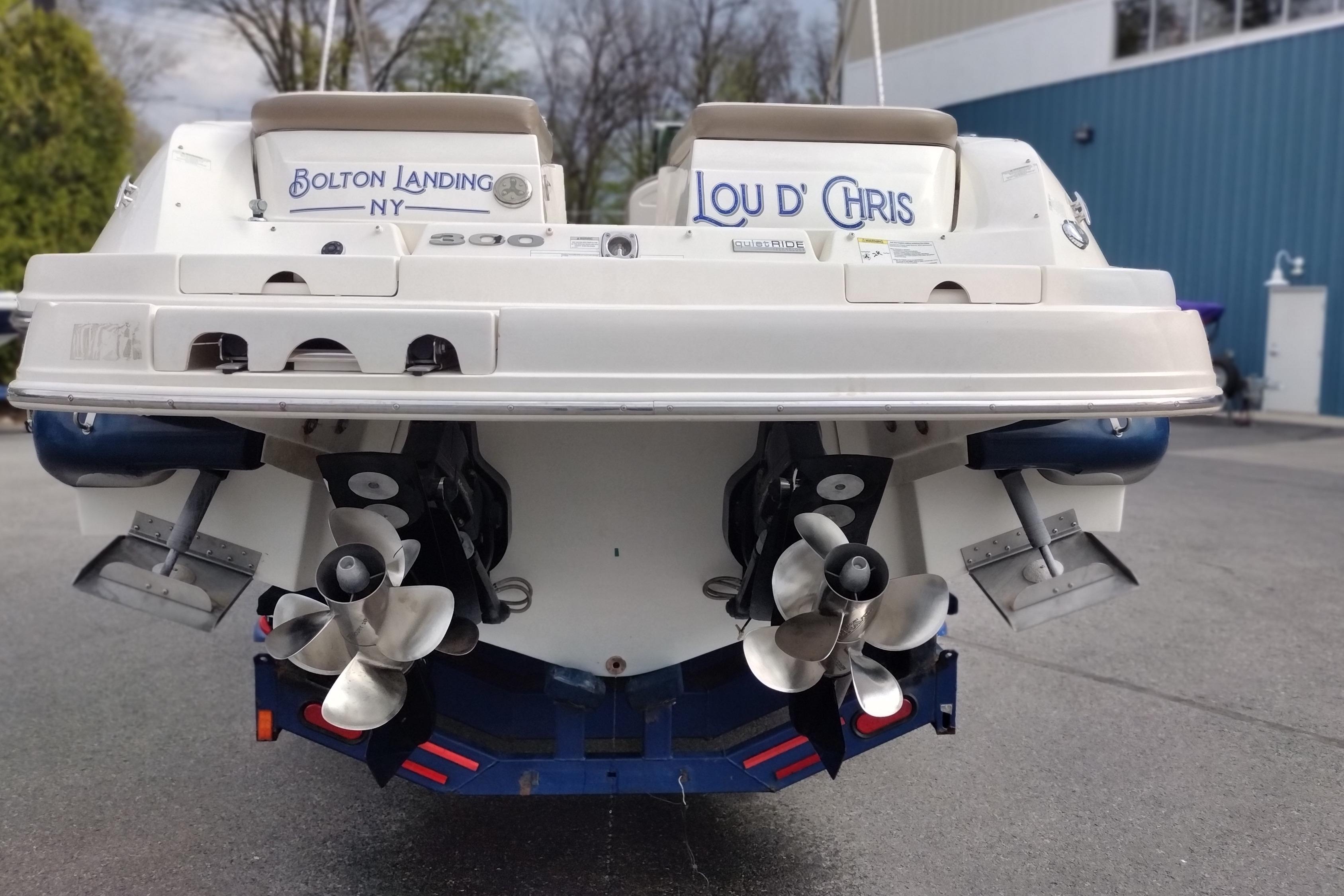 Rear view of a 2013 Sea Ray 300 SLX boat with dual propellers.