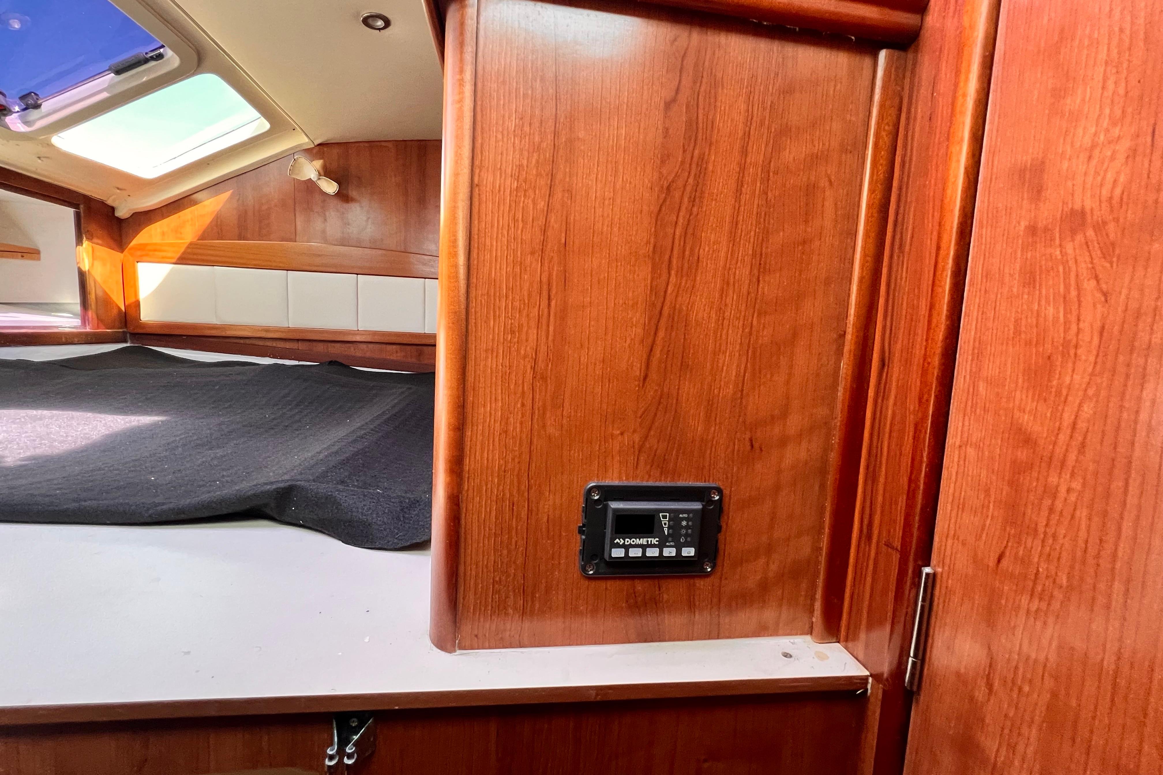 Interior of 2013 Gemini Legacy 35 boat with wood paneling and control panel.