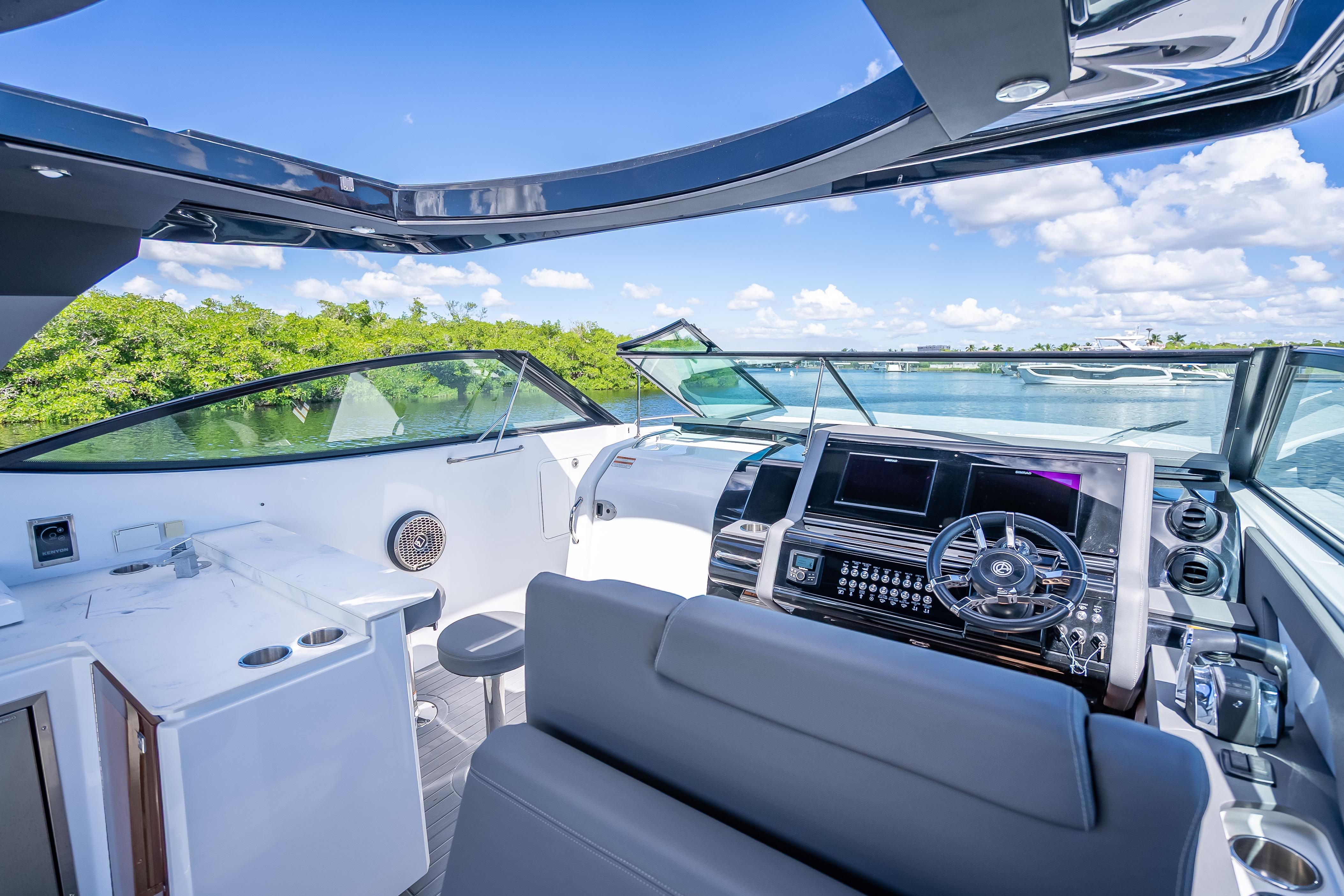 2022 Cruisers Yachts 38 GLS OB cockpit with modern controls and scenic water view.