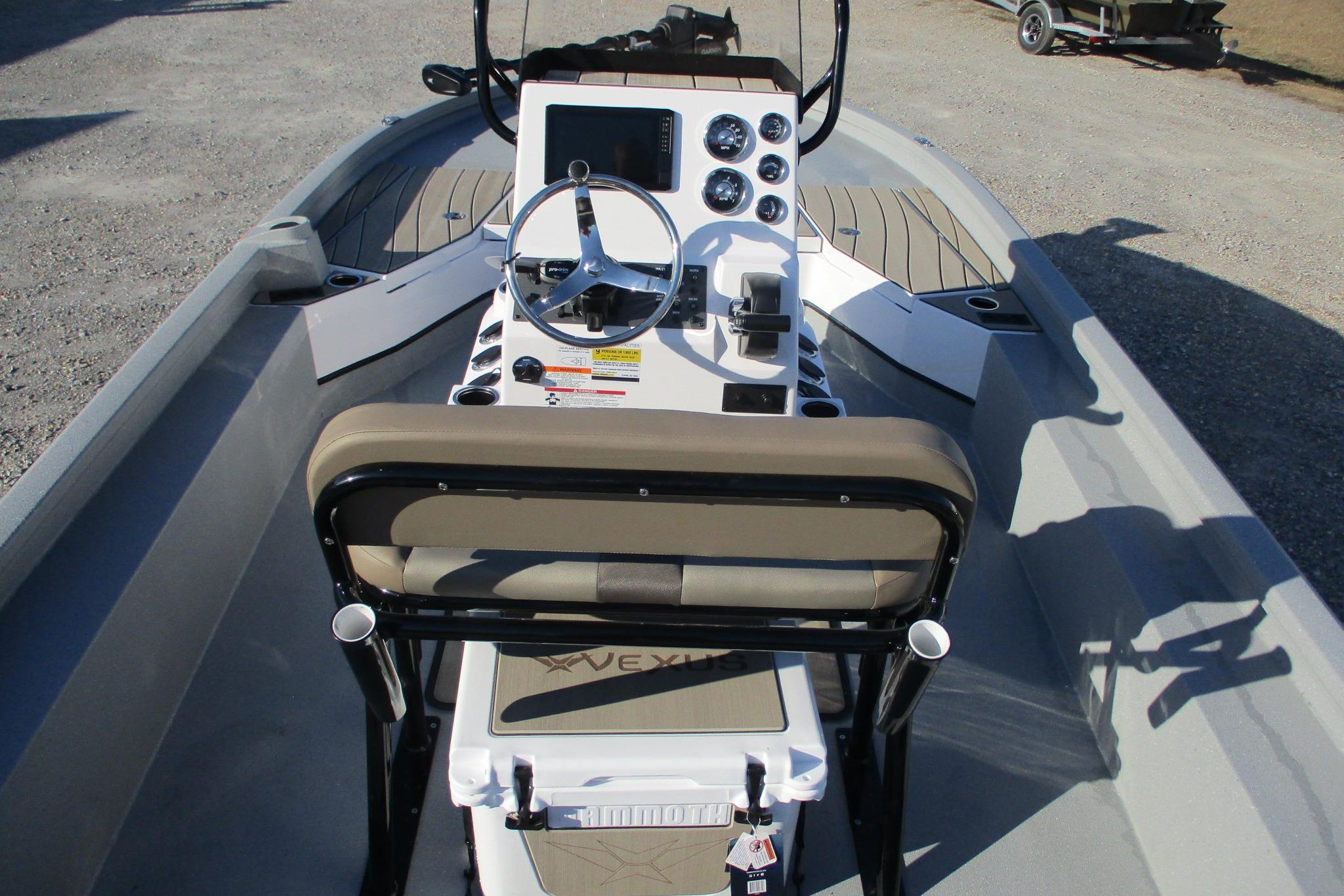 2026 Vexus ACX2210 boat interior with steering console and seating.