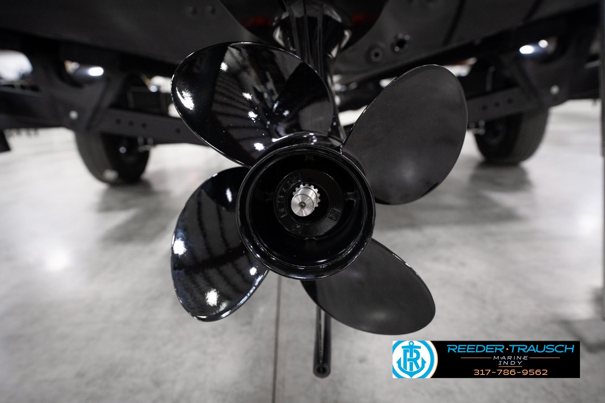 Close-up of a 2026 Lund 1775 Impact XS SS boat propeller in a showroom.