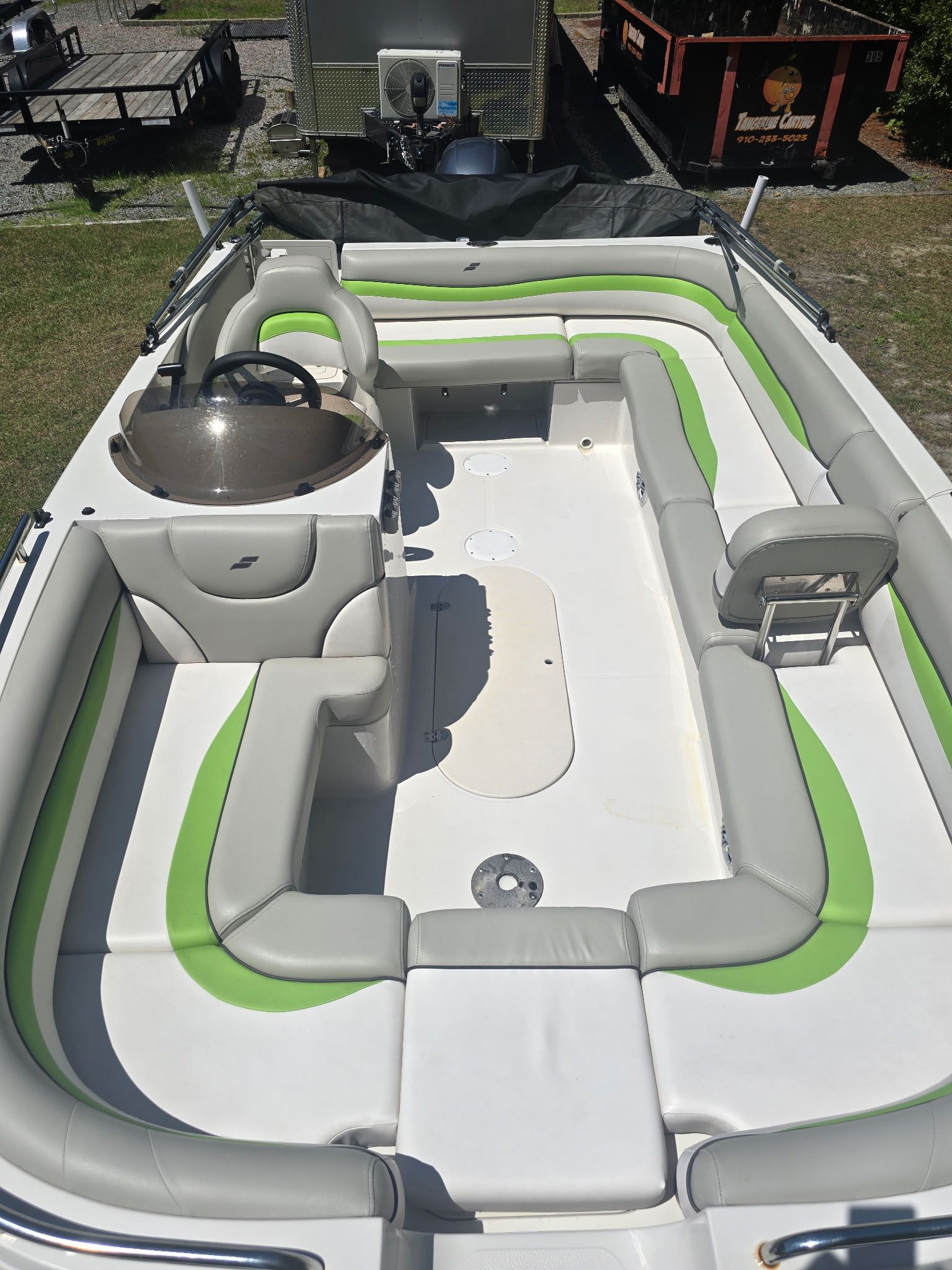 The image shows the deck of a 2017 Starcraft MDX 191 OB boat with green and gray seating.