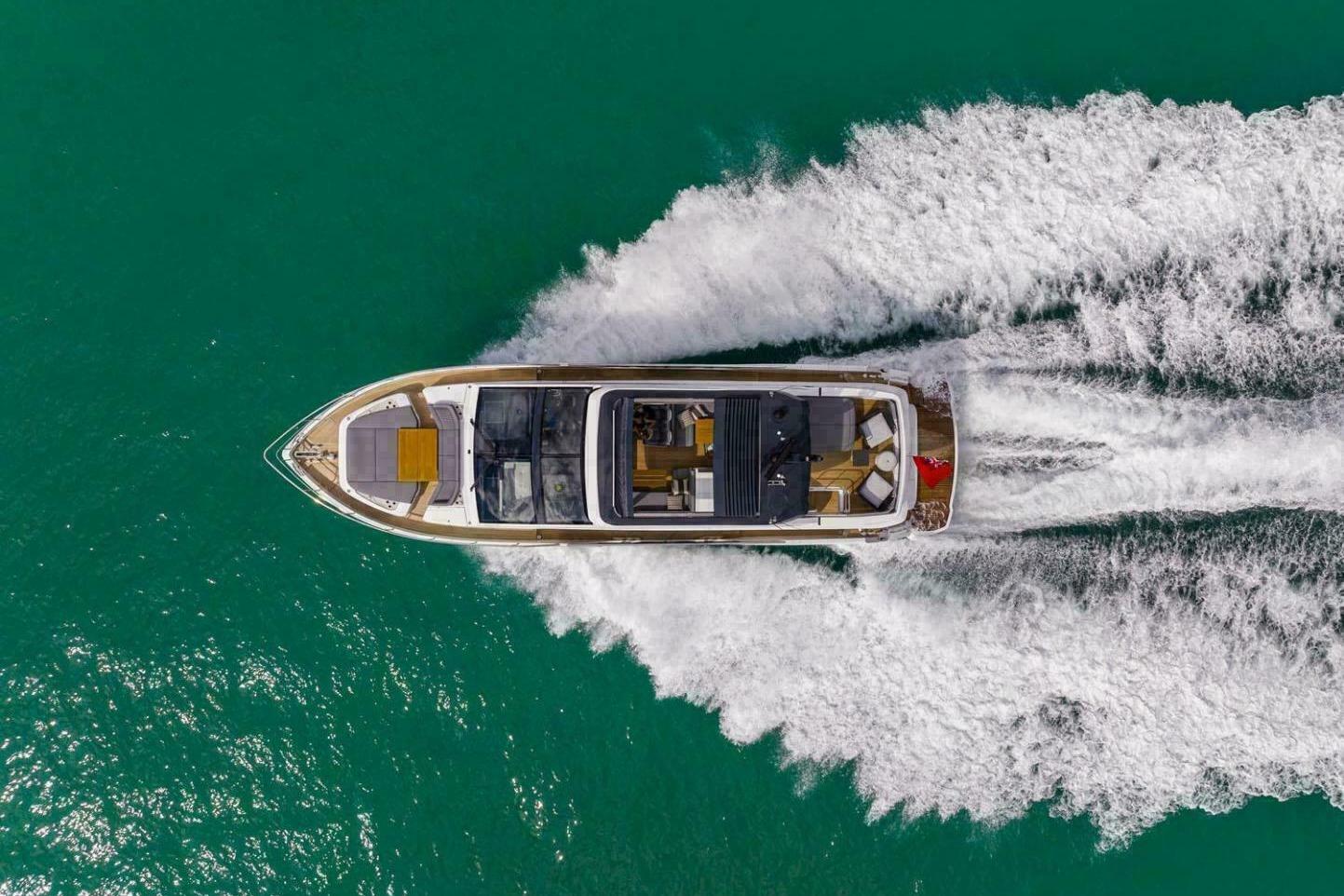 Aerial view of 2023 Pearl 72 yacht cruising on turquoise water.