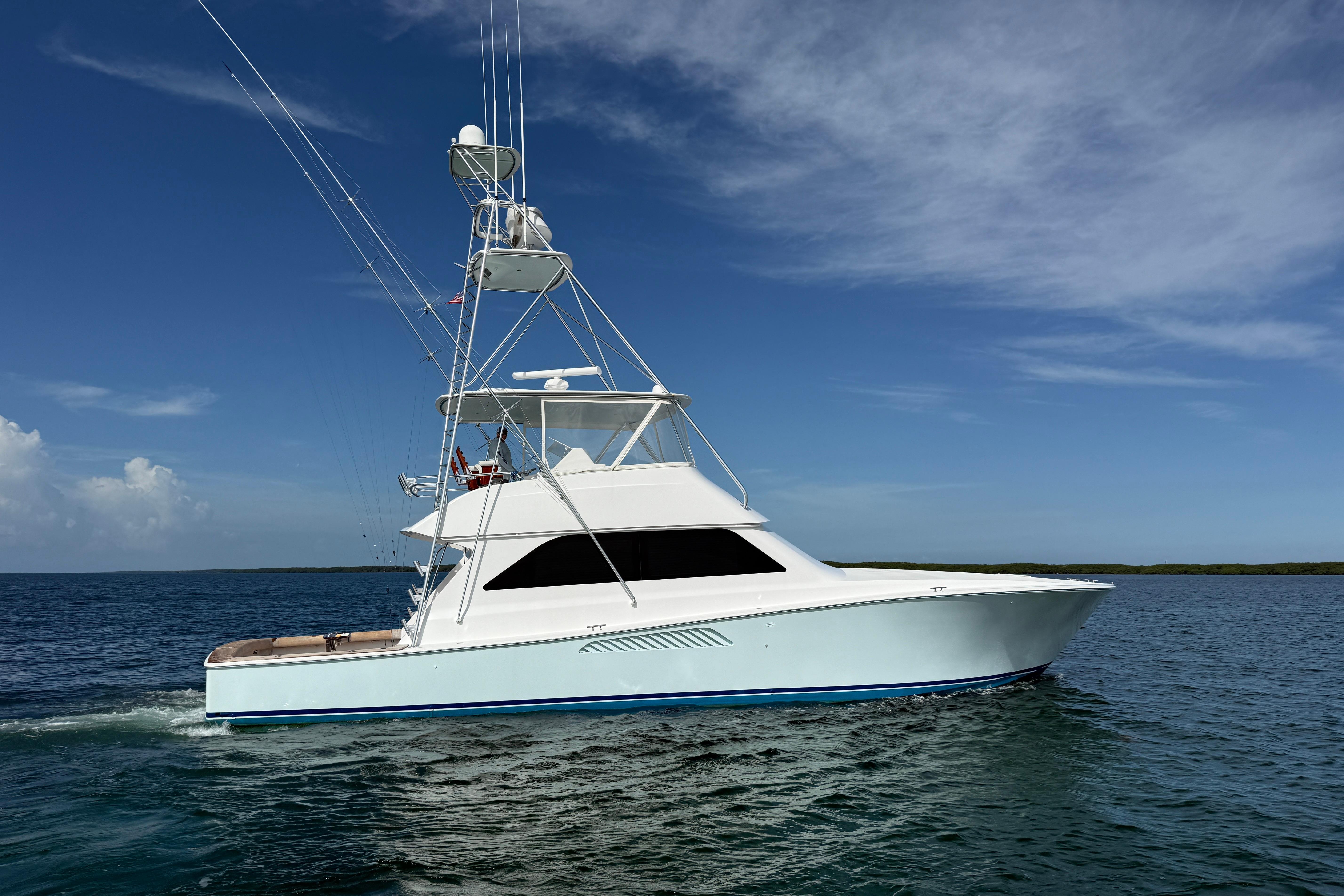 2000 Viking 55 Convertible yacht cruising on open water under clear skies.