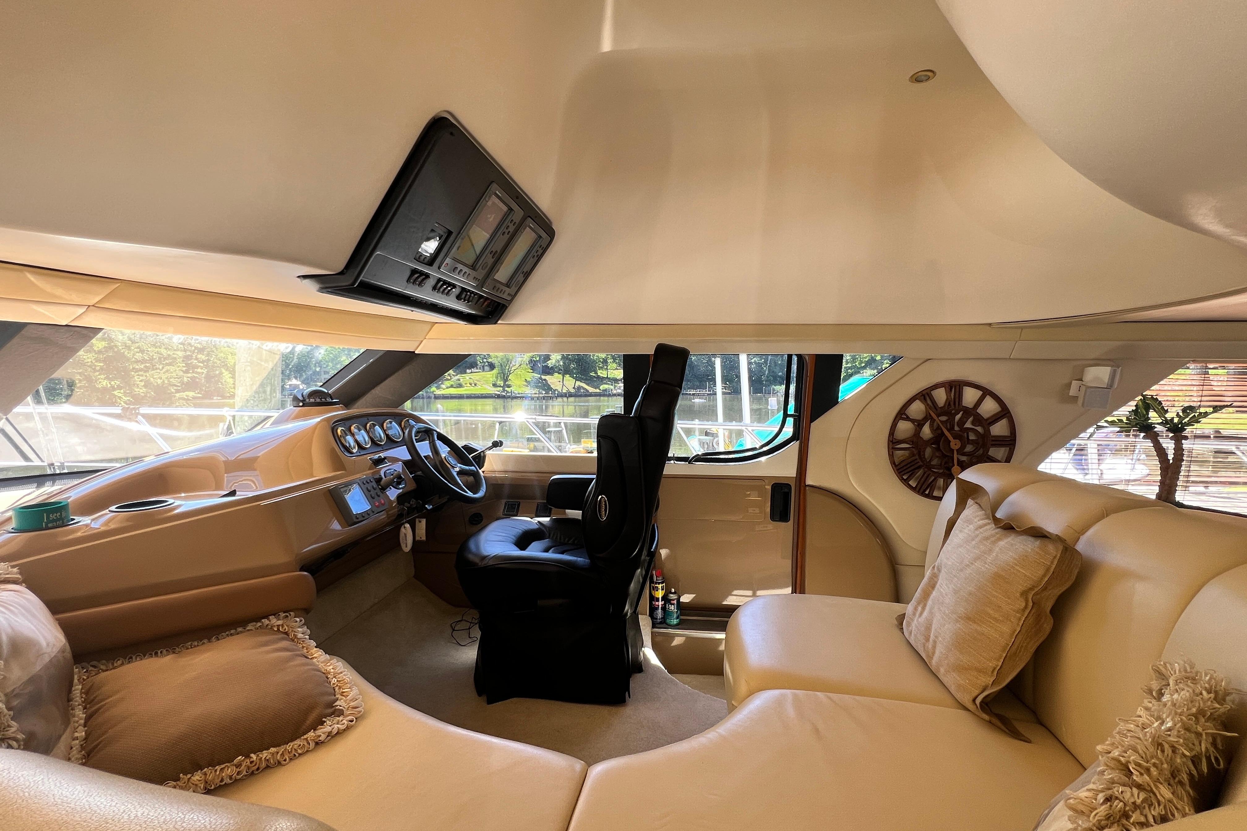 Luxurious interior of 2003 Carver 450 Voyager Pilothouse with plush seating and modern helm.