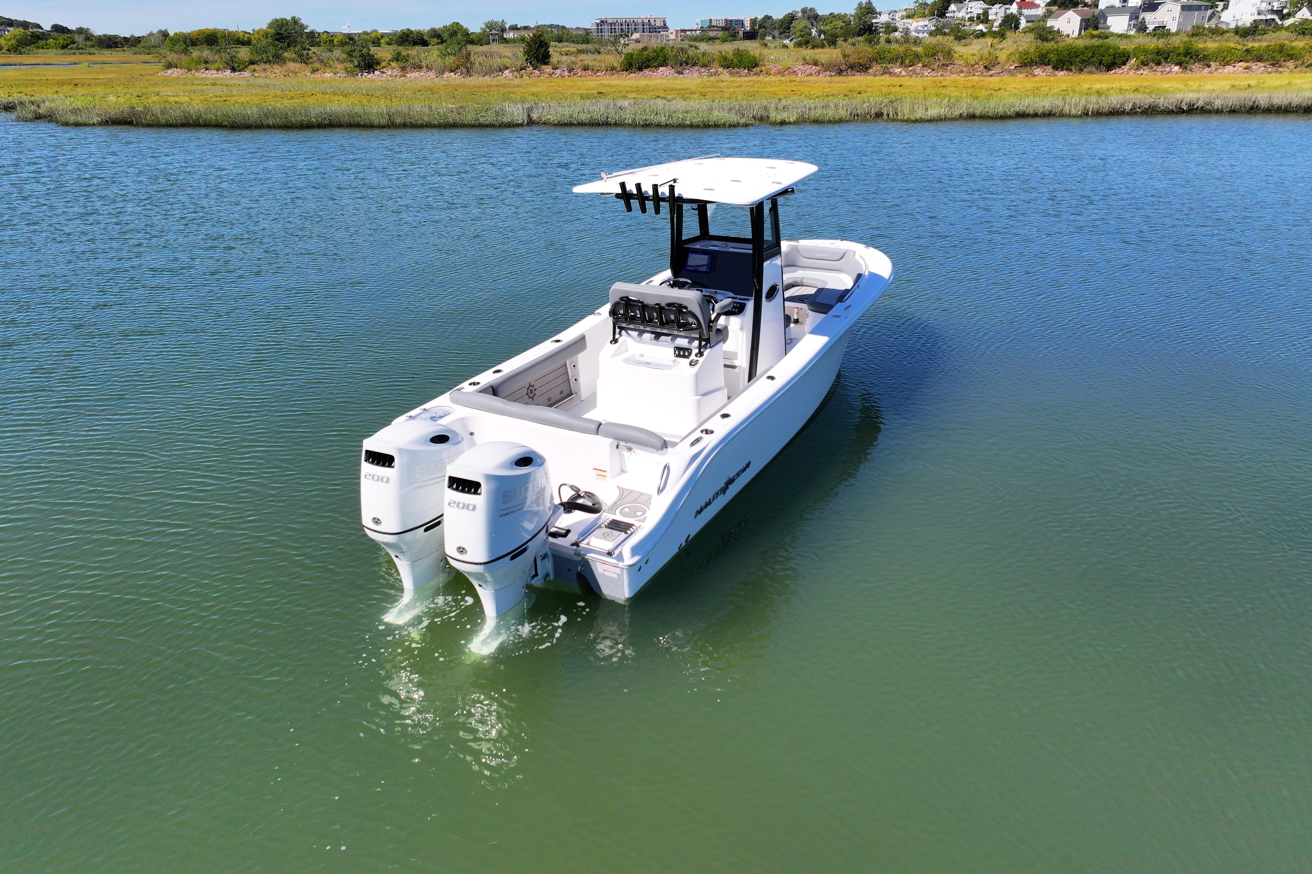2026 NauticStar 252 Legacy boat with dual engines on calm water.