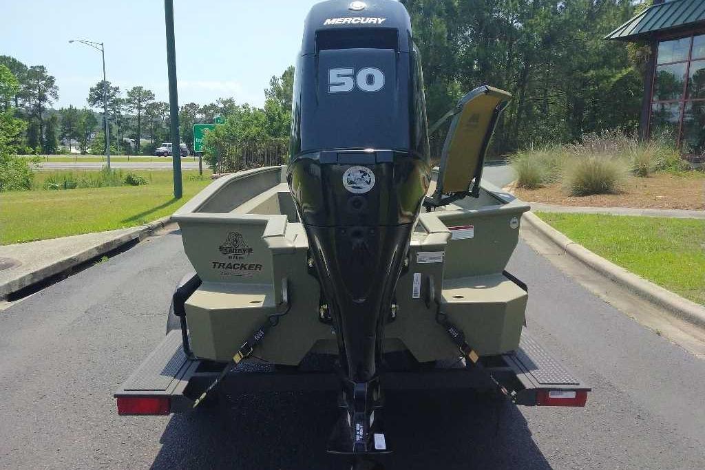 2026 Tracker Grizzly 1650 T Prairie Wings Edition boat with Mercury 50 engine, parked outdoors.