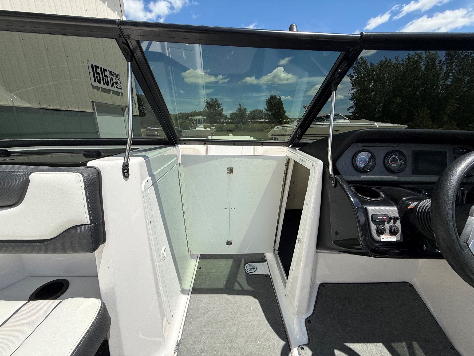 Interior view of a Yamaha SX210 boat with steering console and seating area.