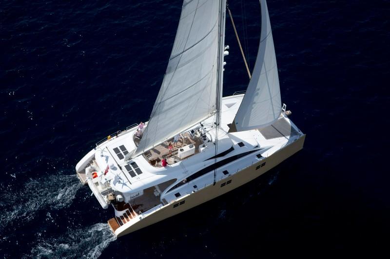 Luxury Sunreef 82 DD catamaran sailing on open sea, 2012 model.