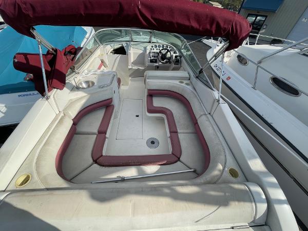 1992 Regal Ventura boat with maroon seating and canopy, spacious deck layout.