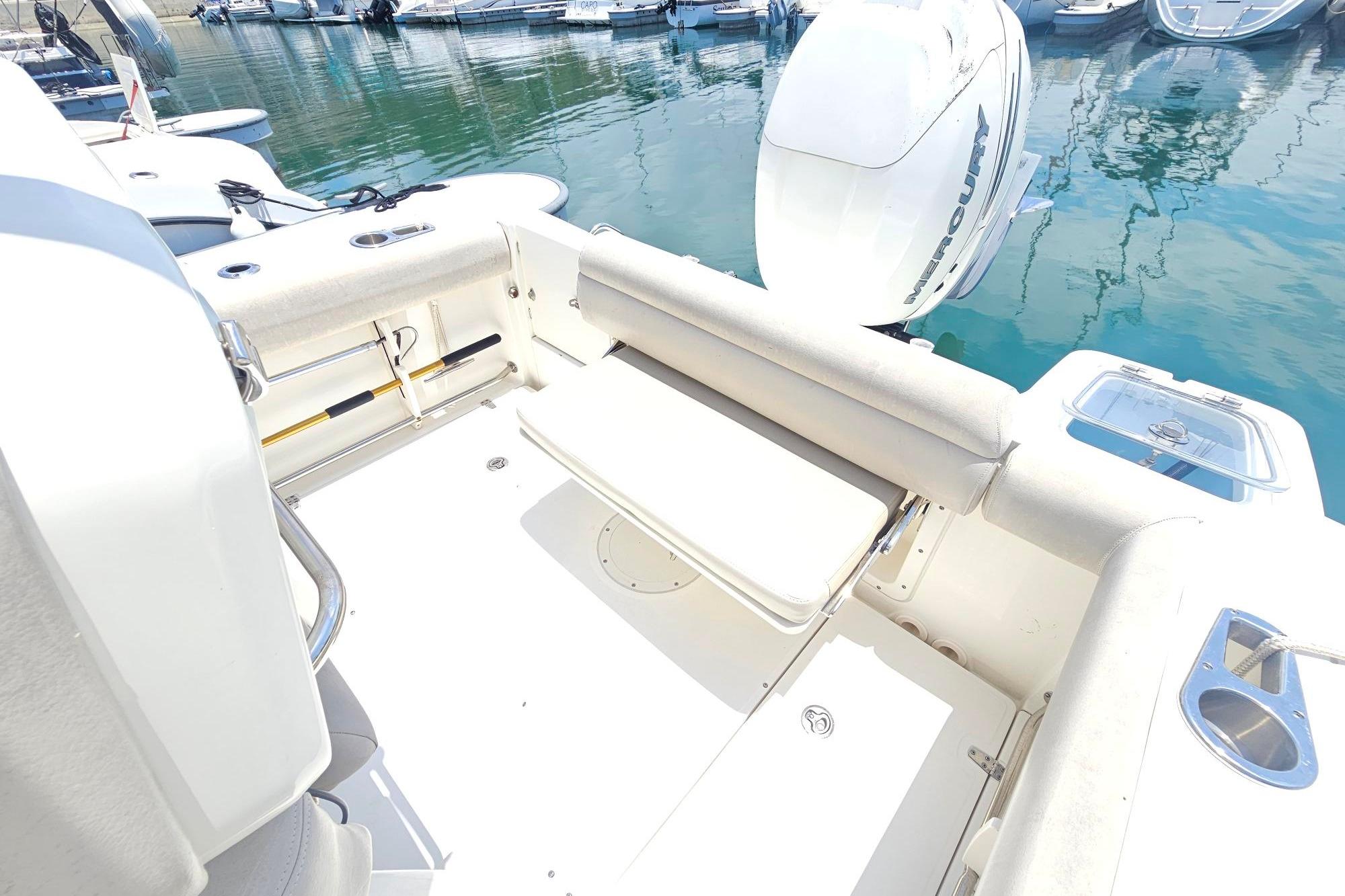 2017 Boston Whaler 230 Outrage boat interior with seating and Mercury outboard engine.