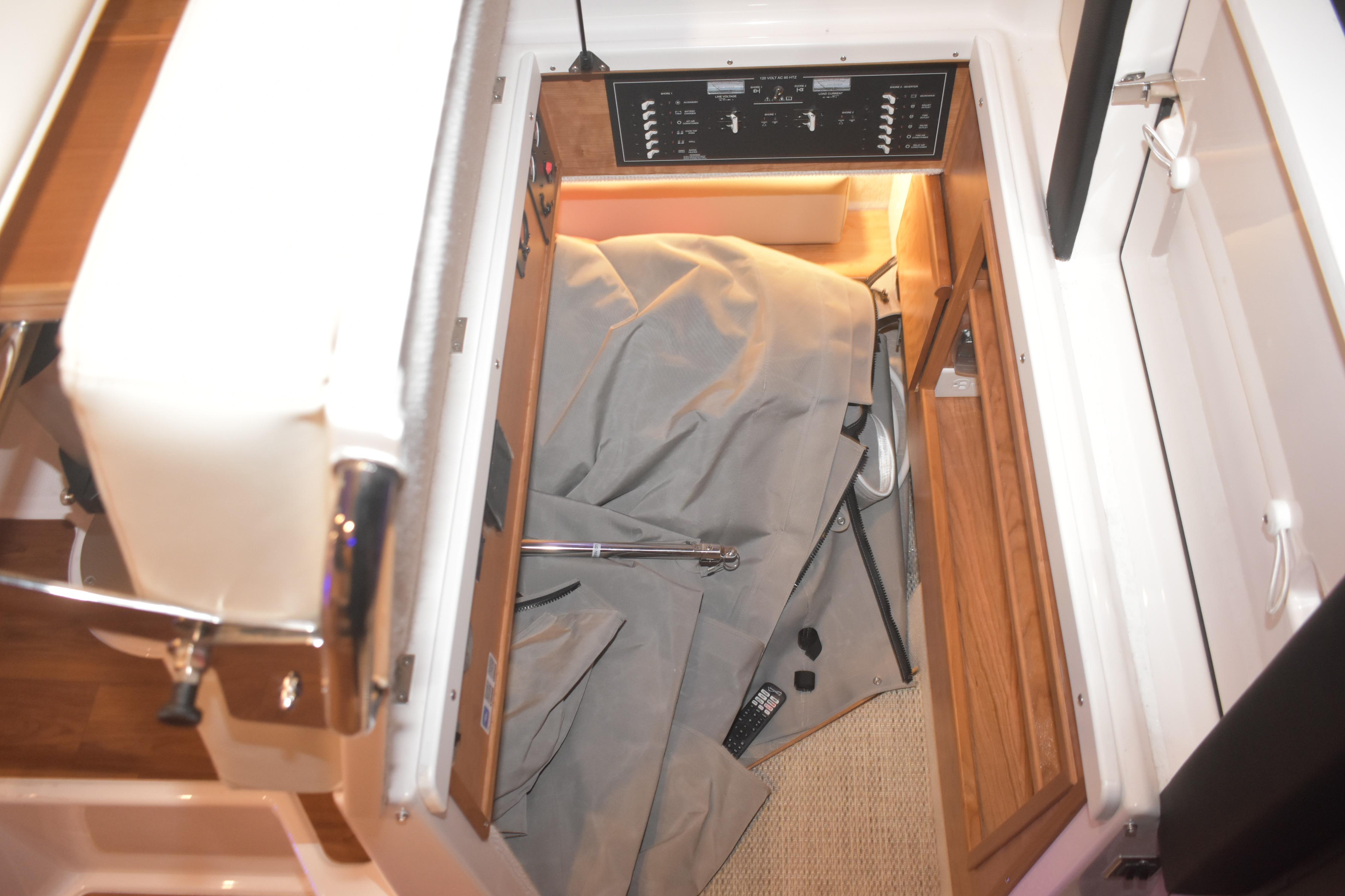 Interior storage area of 2026 Cutwater C-32 CB boat with control panel.