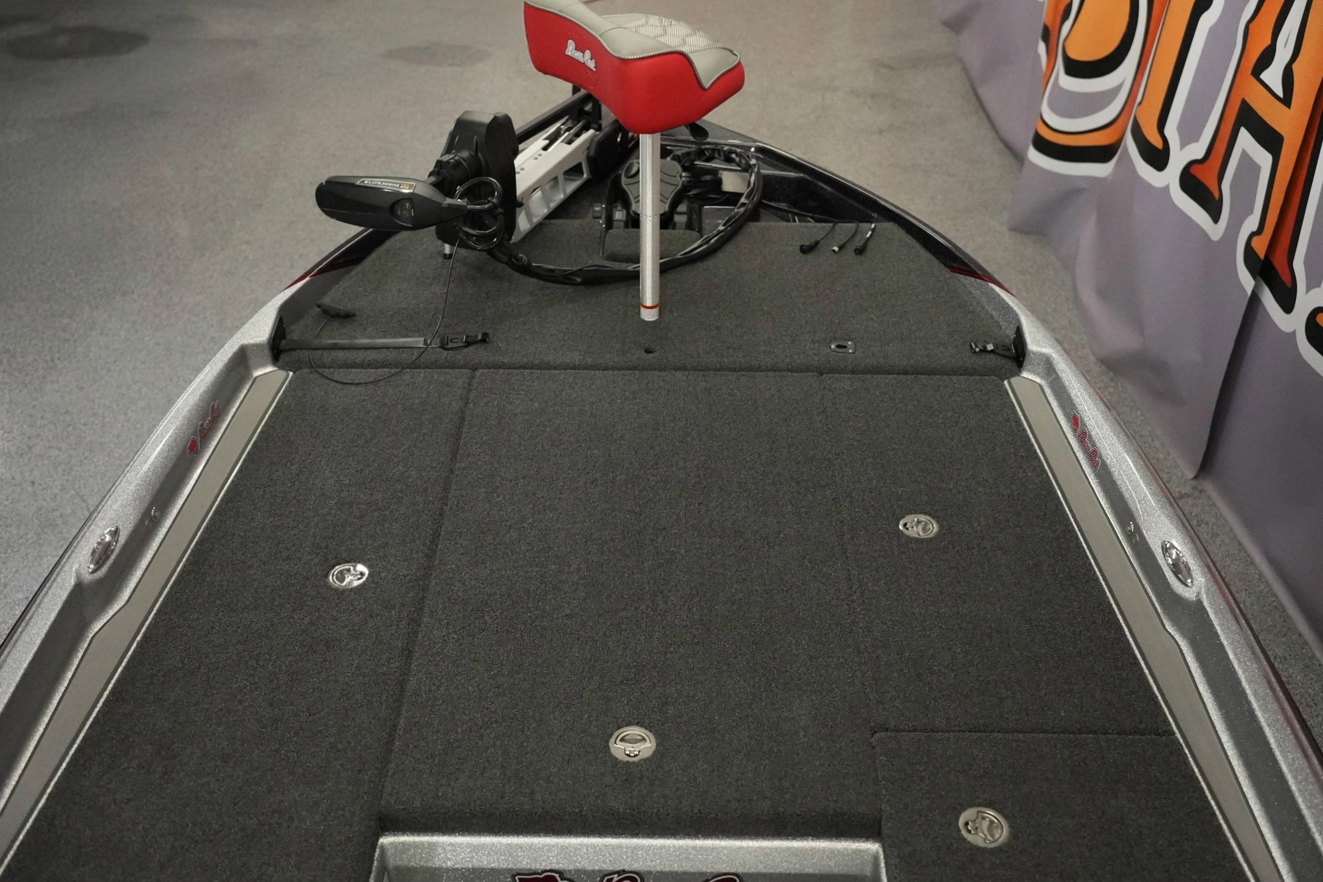 2026 Bass Cat Lynx STS boat deck with red seat and fishing equipment.