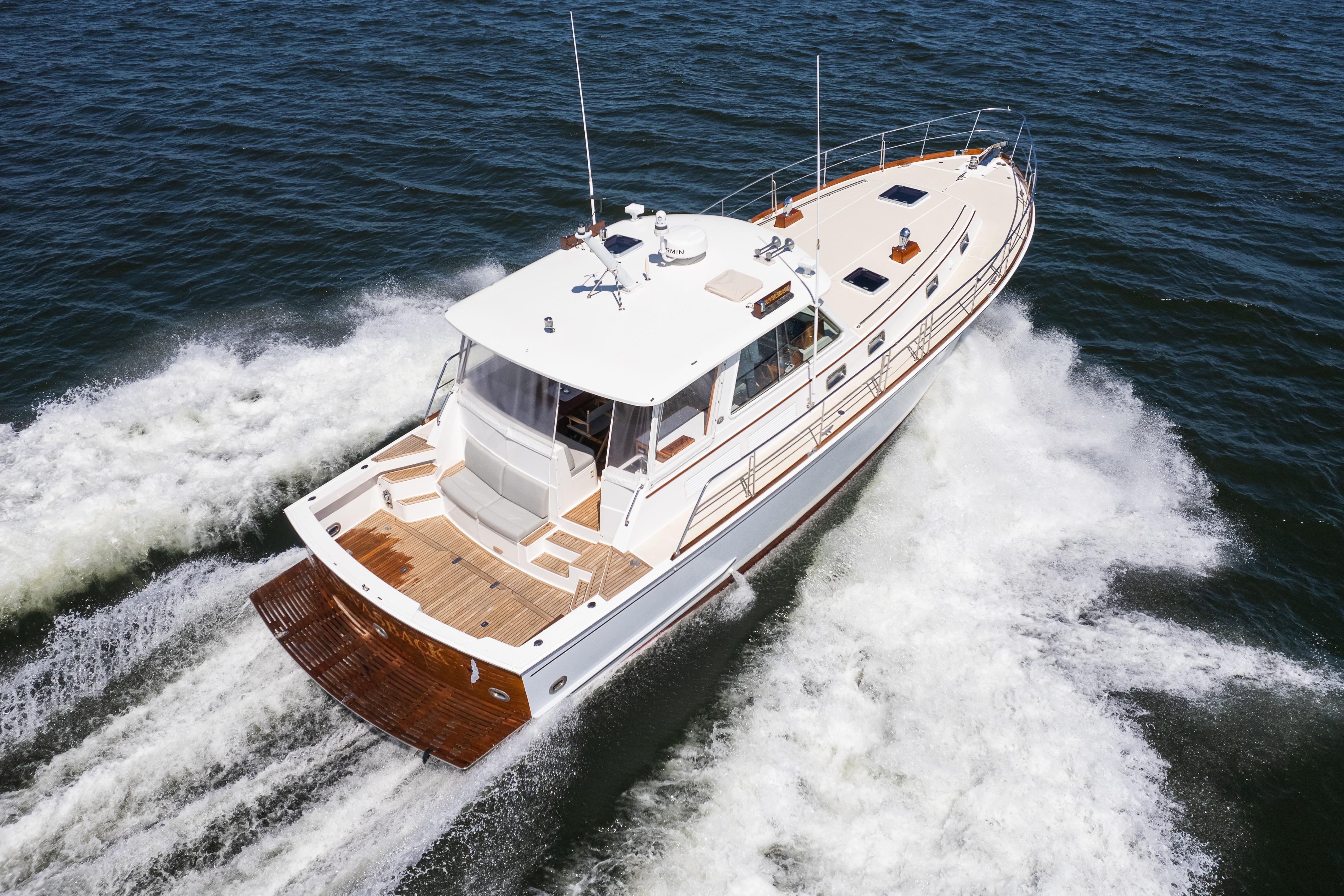 1999 Grand Banks 49 Eastbay HX cruising on open water, showcasing elegant design and performance.
