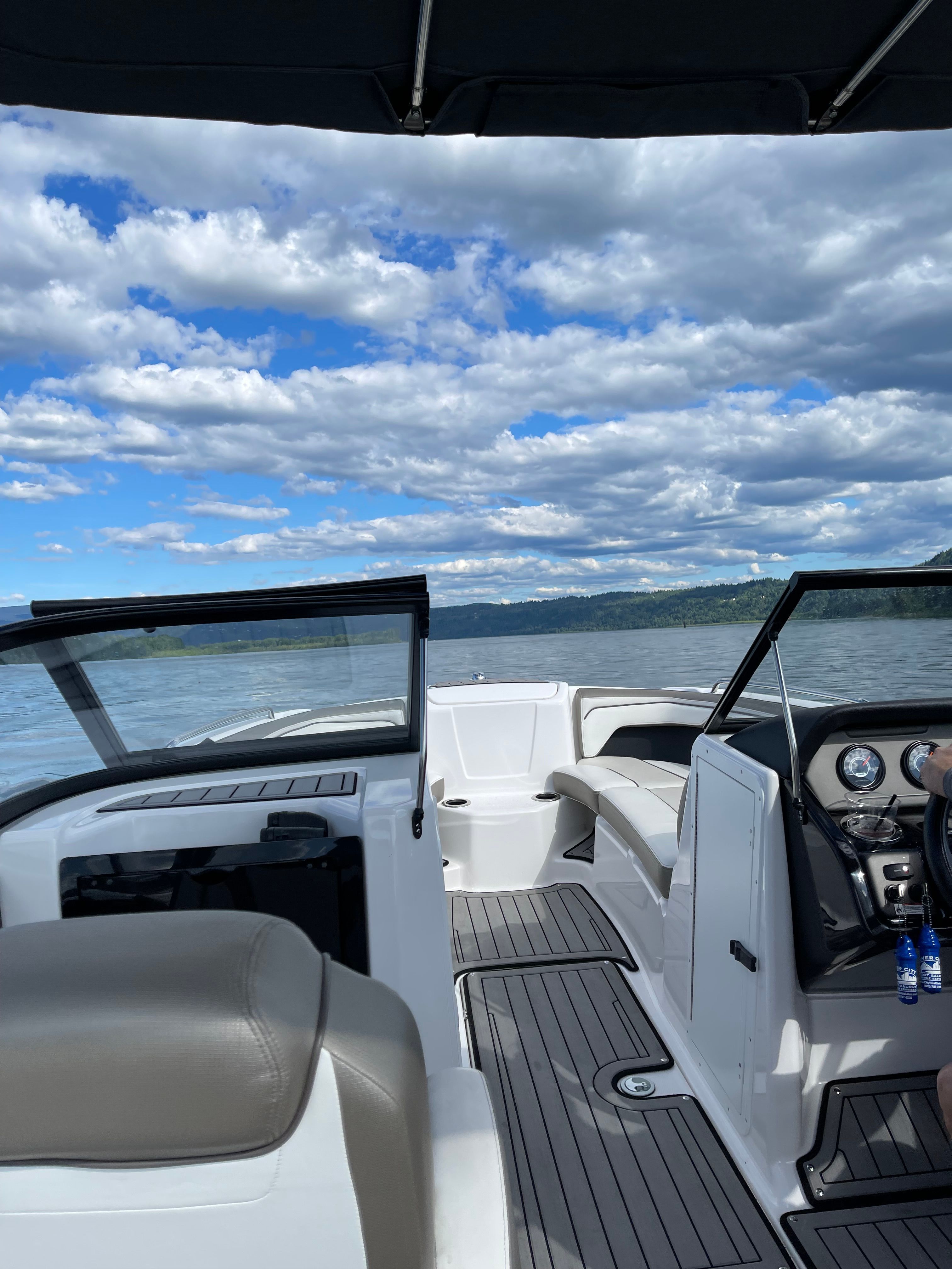 2018 Yamaha 212 Limited S on calm water under a cloudy sky.