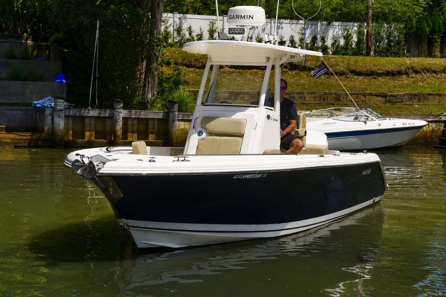 2020 Pursuit C 238 Center Console boat docked in calm waters.