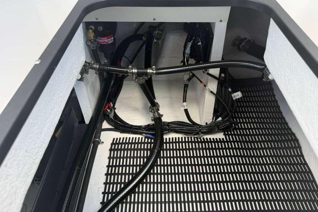 Engine compartment of 2026 Monterey Elite 30 OB boat with visible wiring and hoses.
