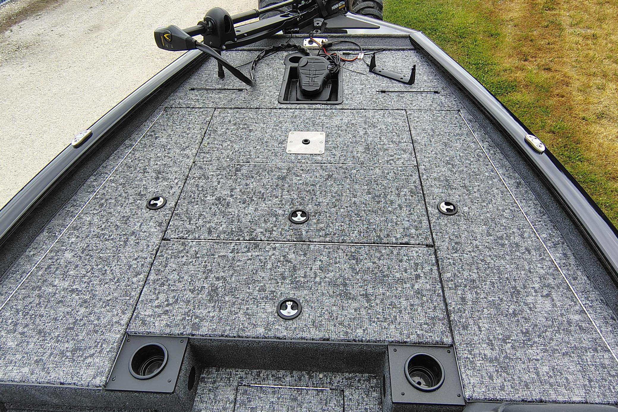 2026 Tracker Pro Team 195 boat deck with storage compartments and trolling motor.