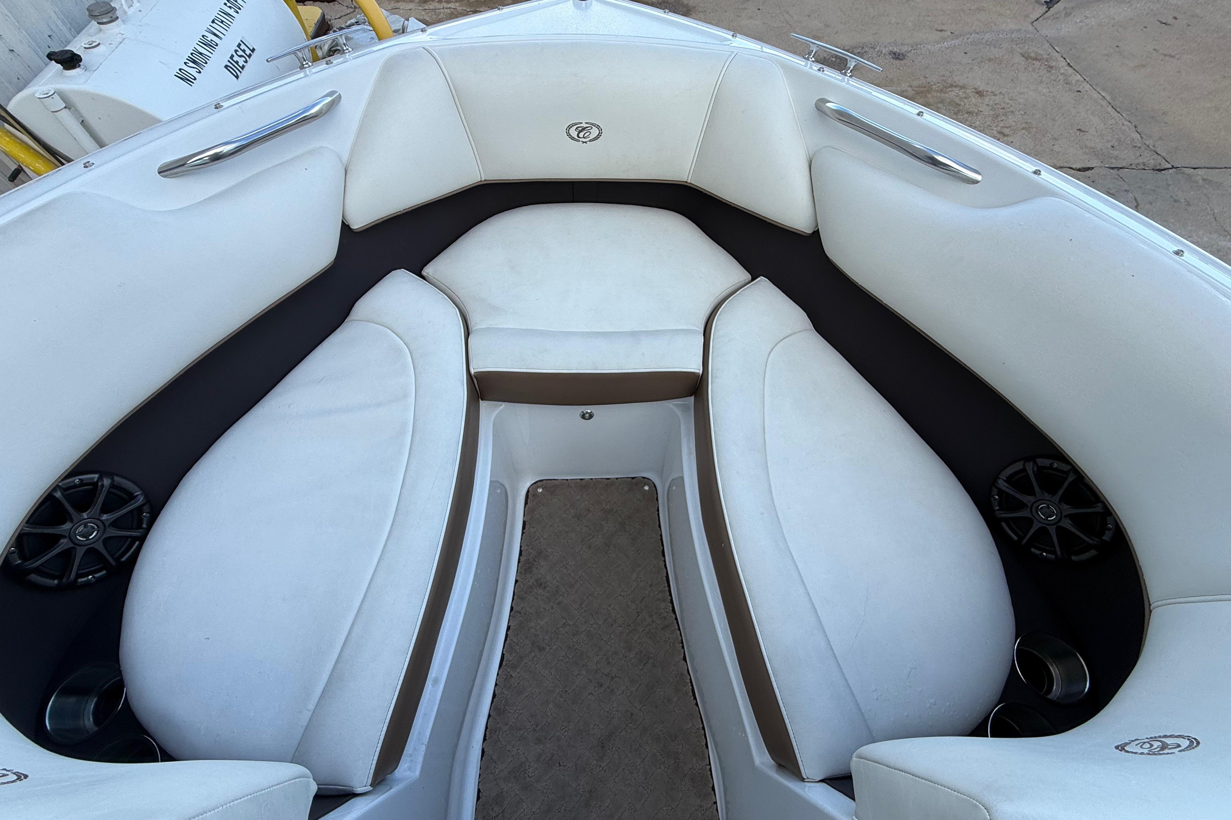 Interior of a 2015 Cobalt 200 boat with white cushioned seating.