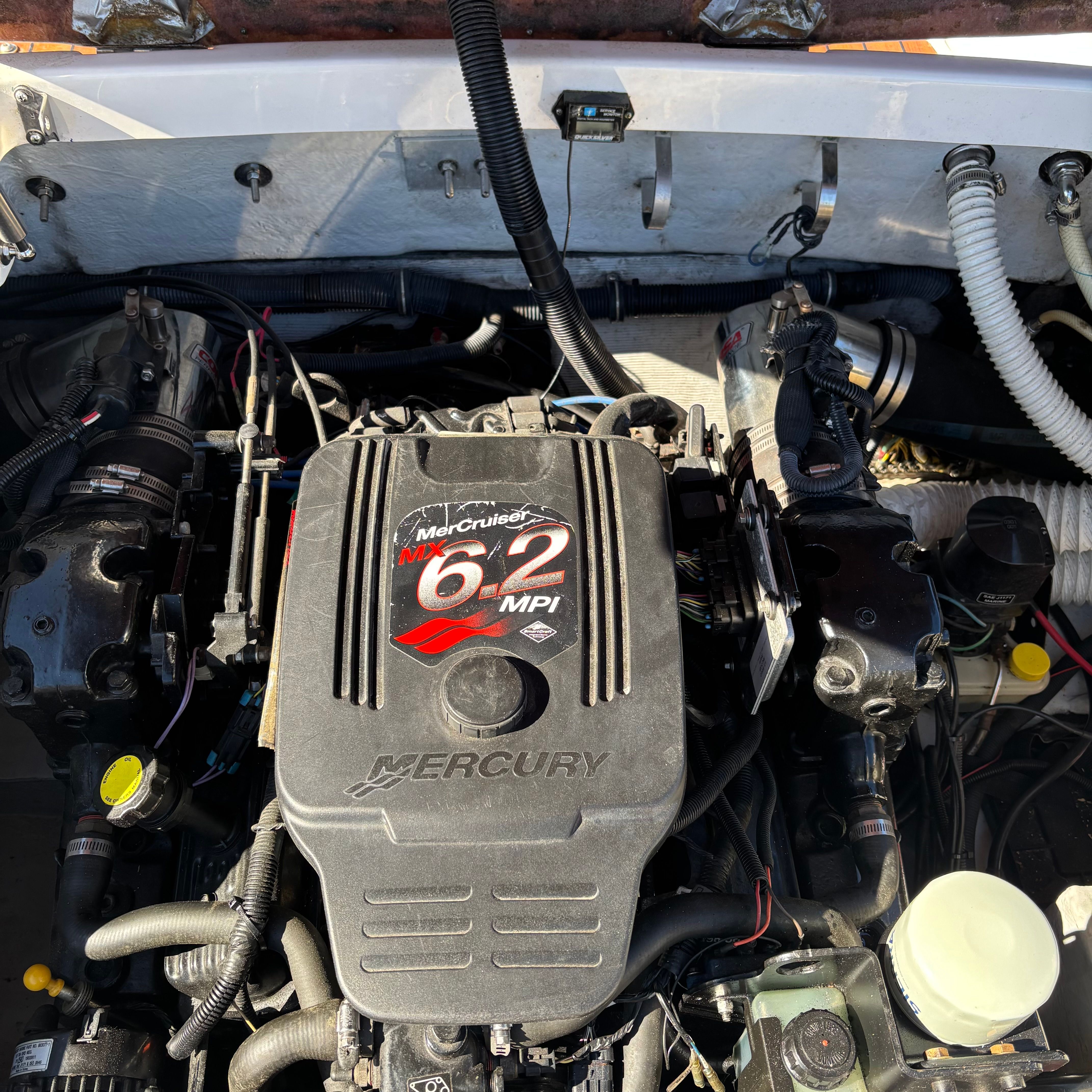 Engine compartment of a Chris-Craft Launch 22 boat featuring a Mercury 6.2 MPI engine.