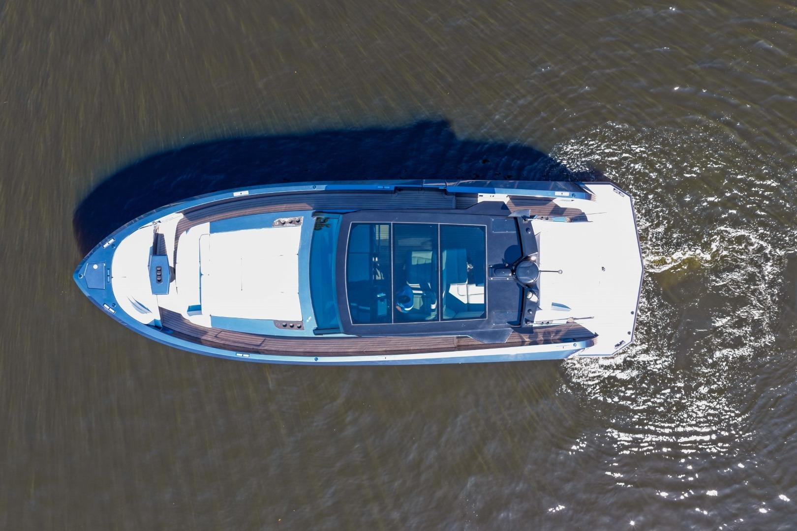 Aerial view of 2022 Vanquish Yachts VQ45 cruising on water.