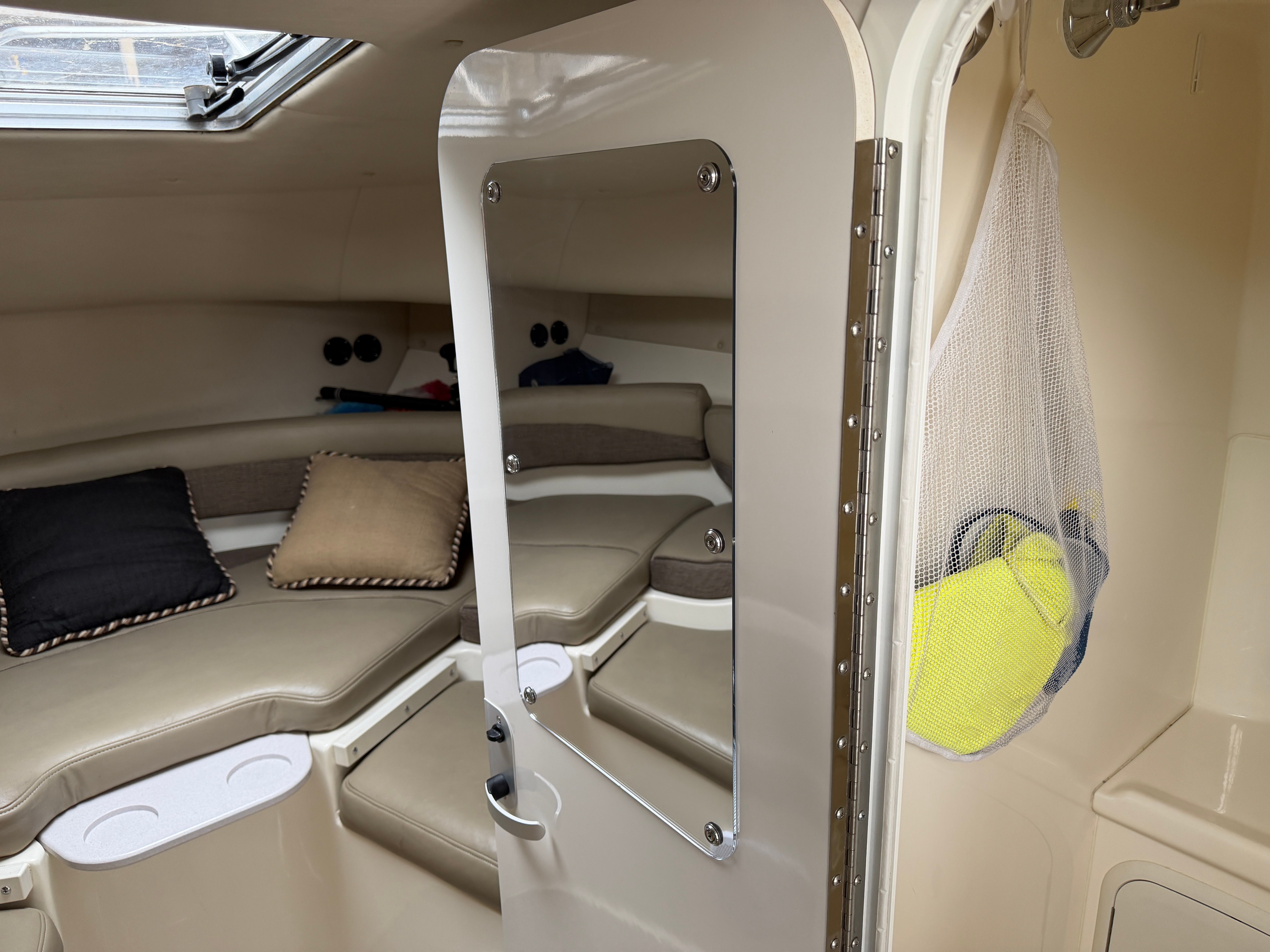 Interior of a 2001 Boston Whaler 26 Conquest with seating area and storage.