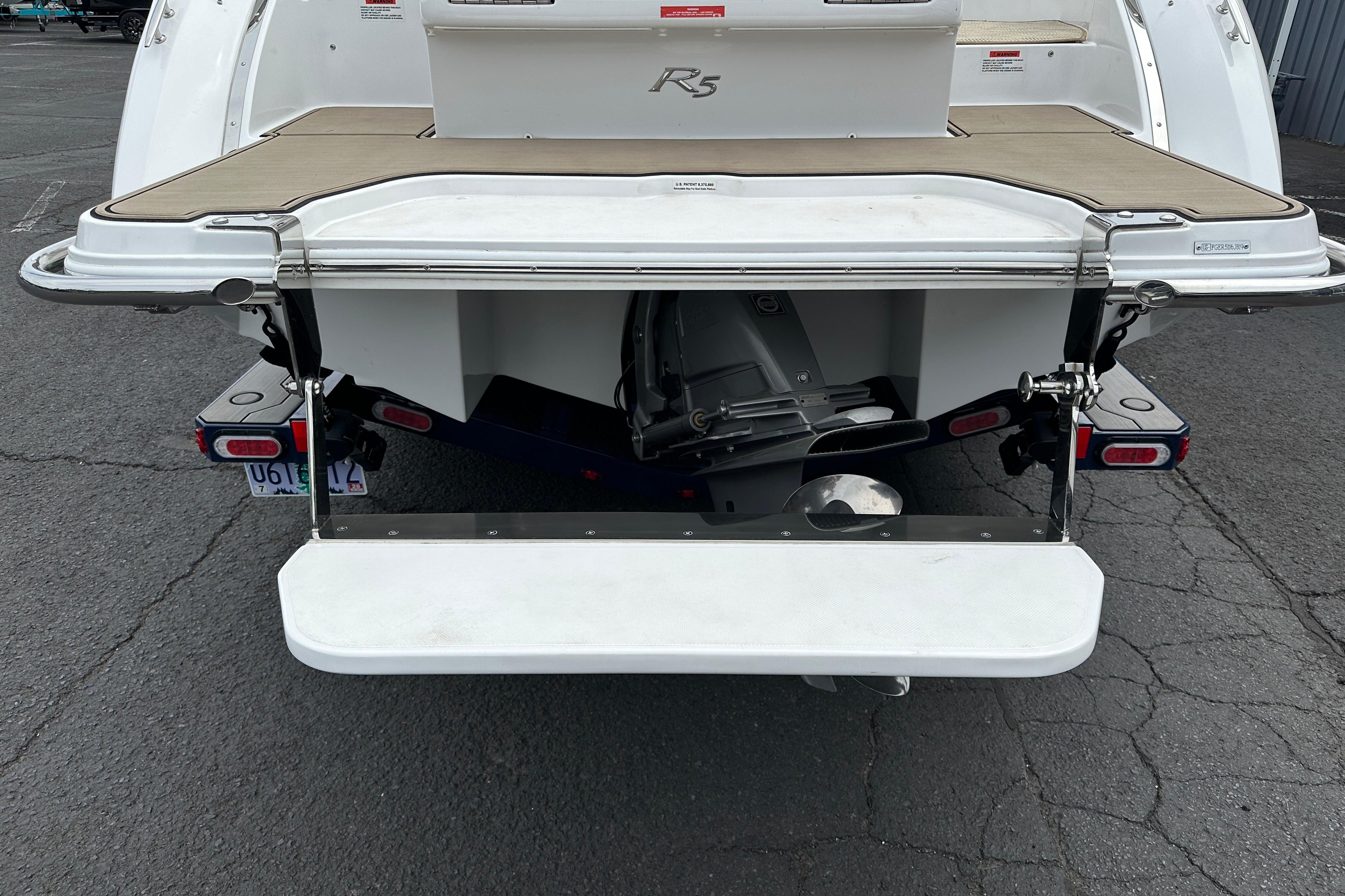 2019 Cobalt R5 boat stern with swim platform and outboard motor.