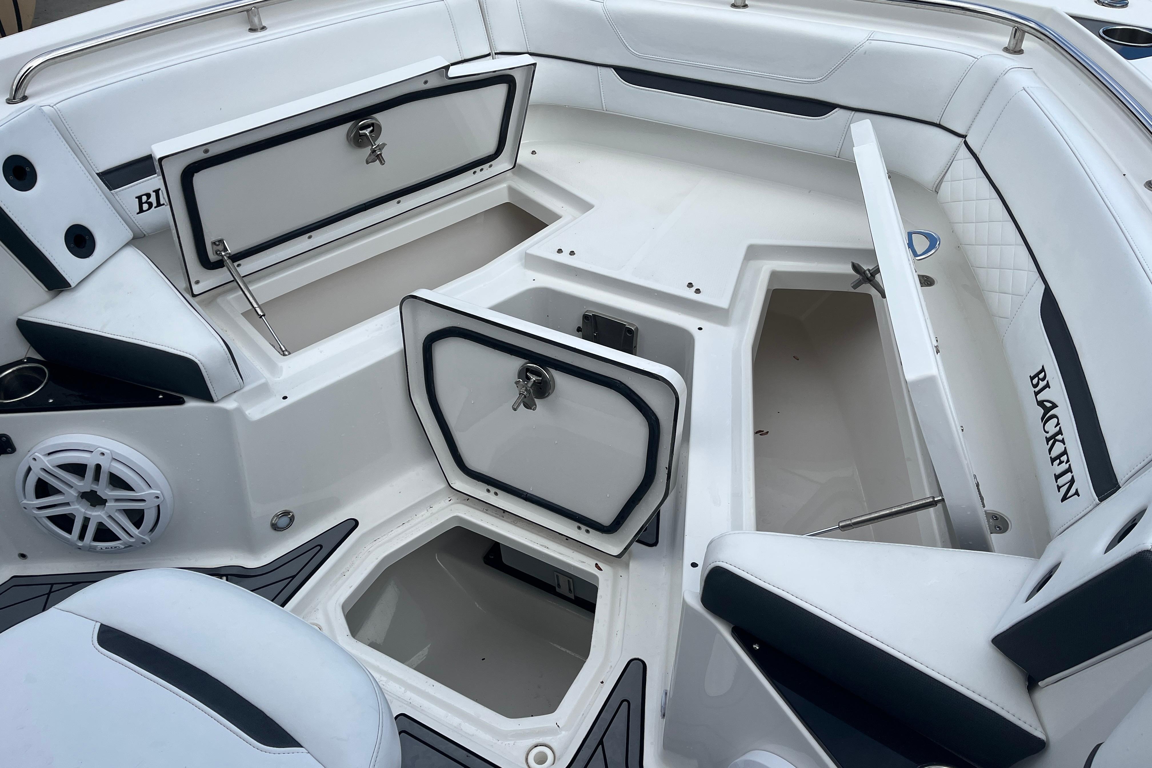 2021 Blackfin 252 CC boat interior with open storage compartments and seating.