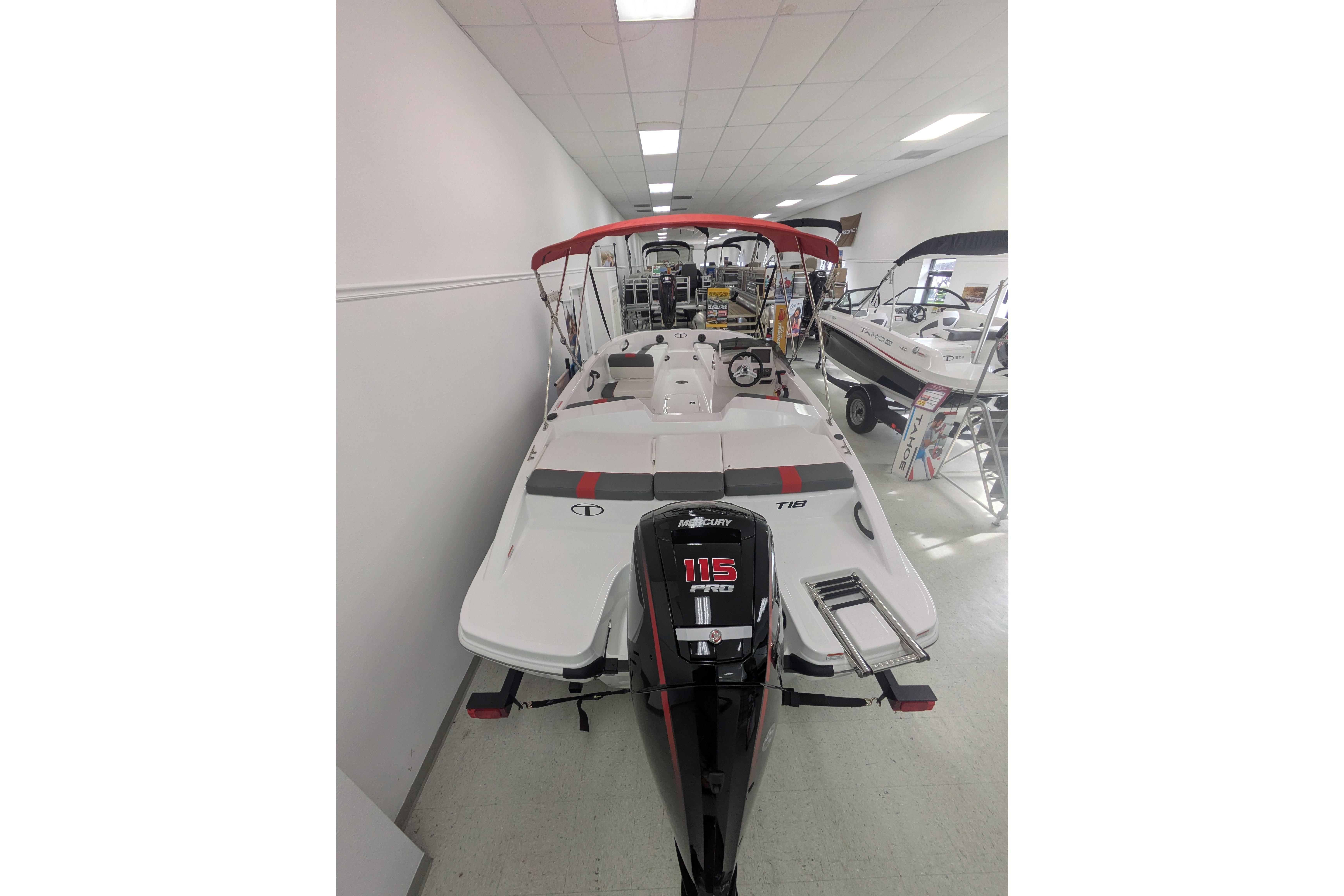 2026 Tahoe T18 boat with Mercury 115 engine displayed indoors.