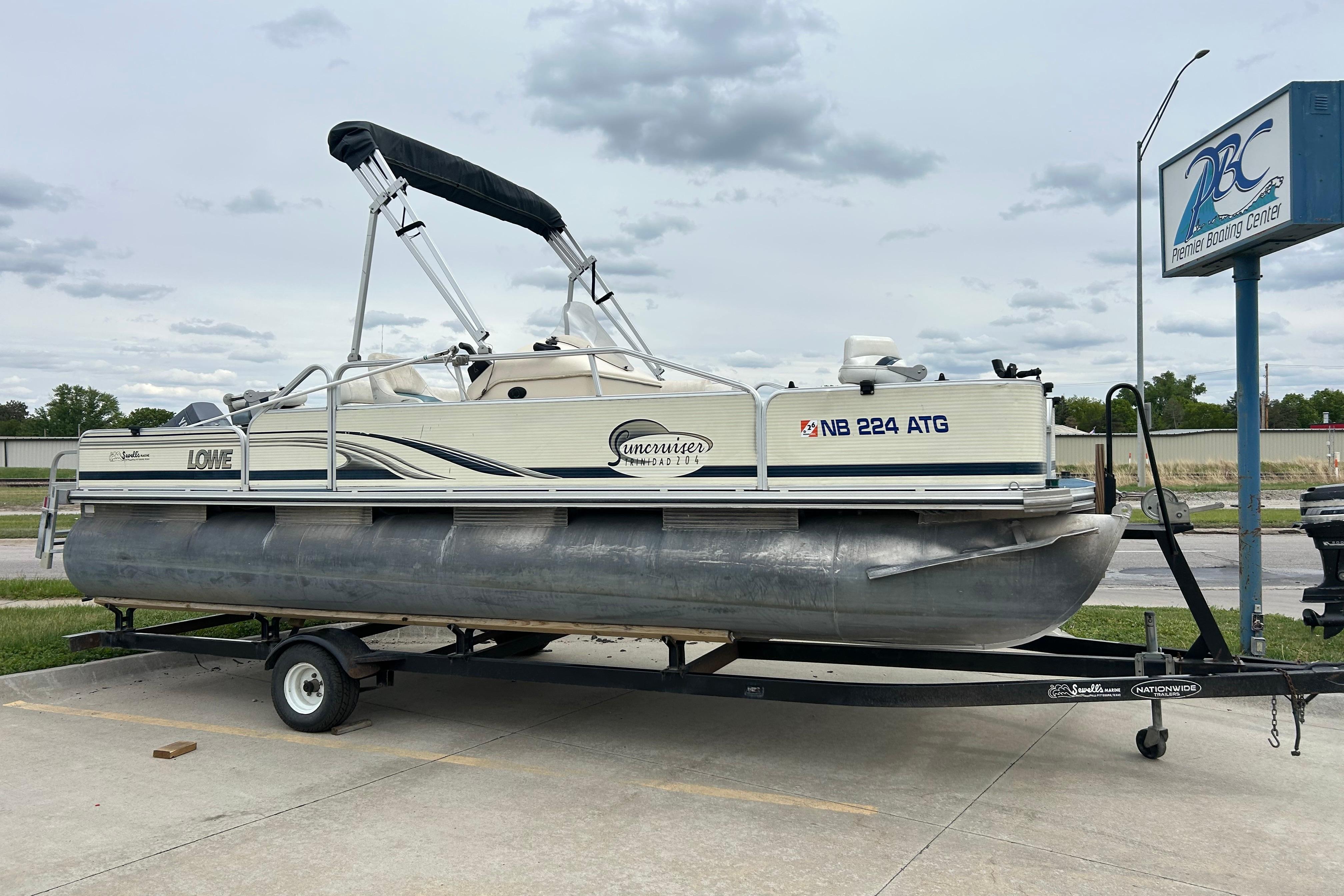 2002 Lowe Trinidad 200 pontoon boat on trailer at Premier Boating Center.