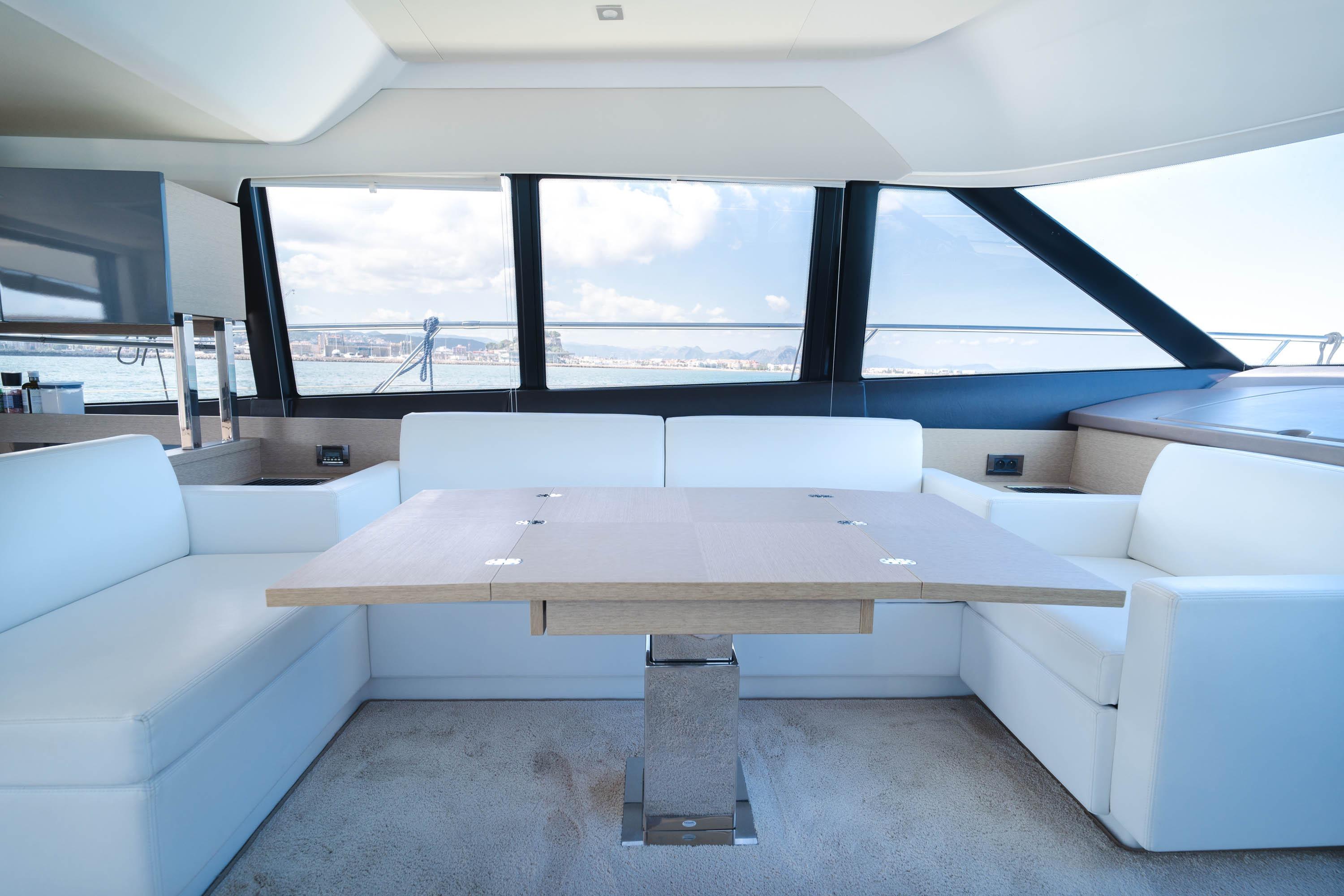 Luxurious interior of 2017 Prestige 560 yacht with elegant seating and table.