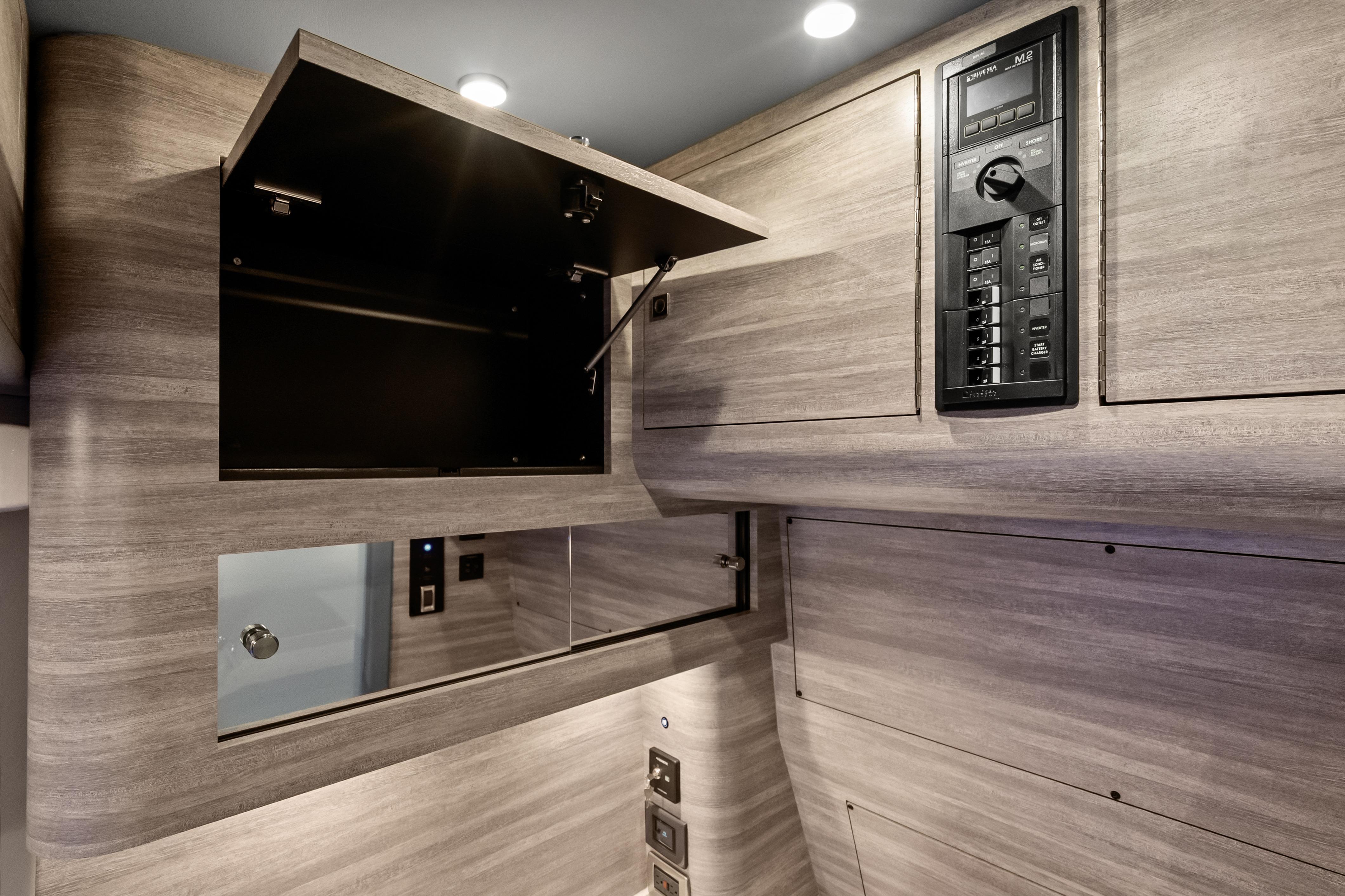 Interior of 2027 Mystic Powerboats M4200, featuring sleek cabinetry and control panel.