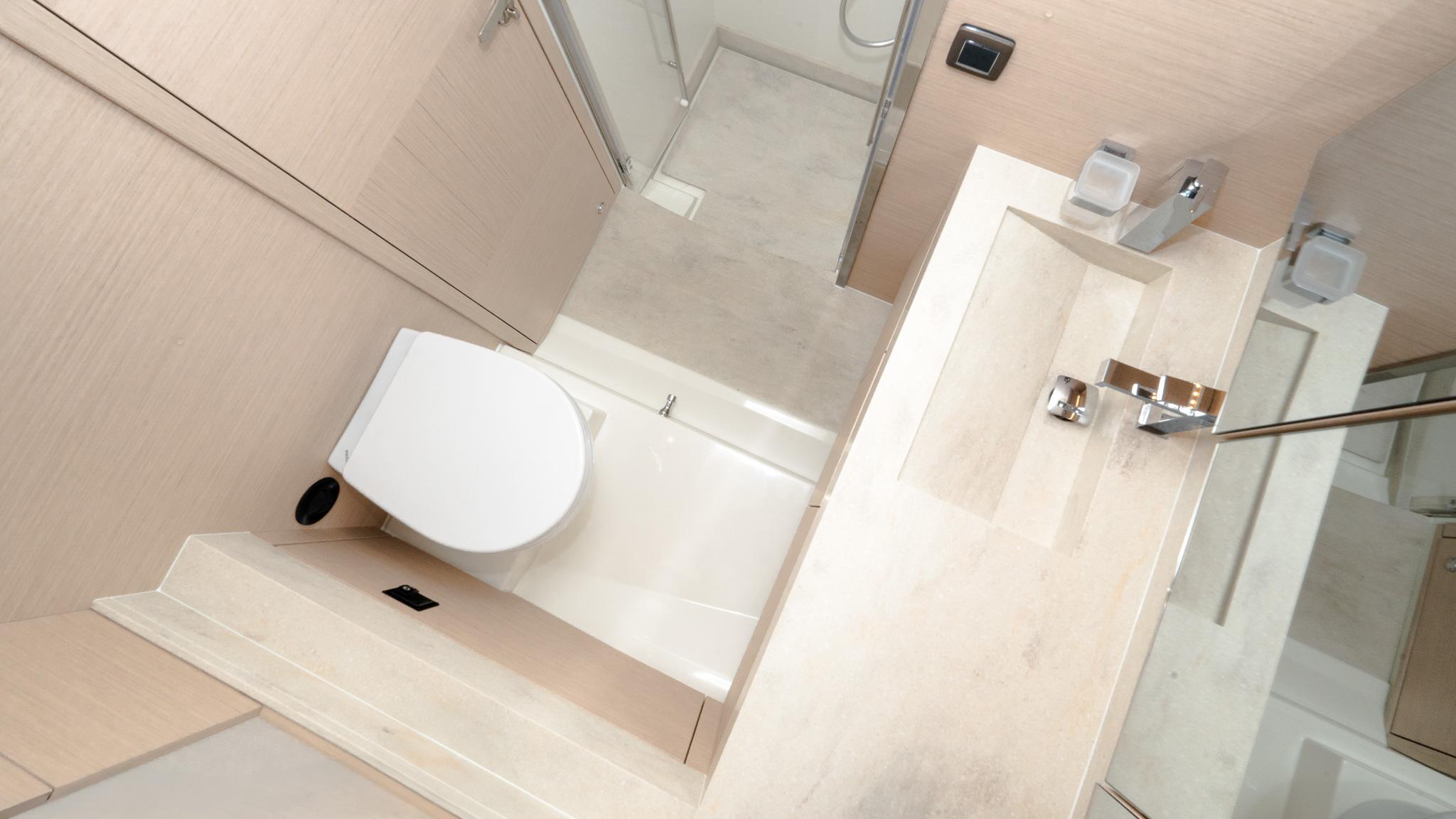 Modern bathroom in 2023 Prestige 520S yacht, featuring sleek fixtures and minimalist design.