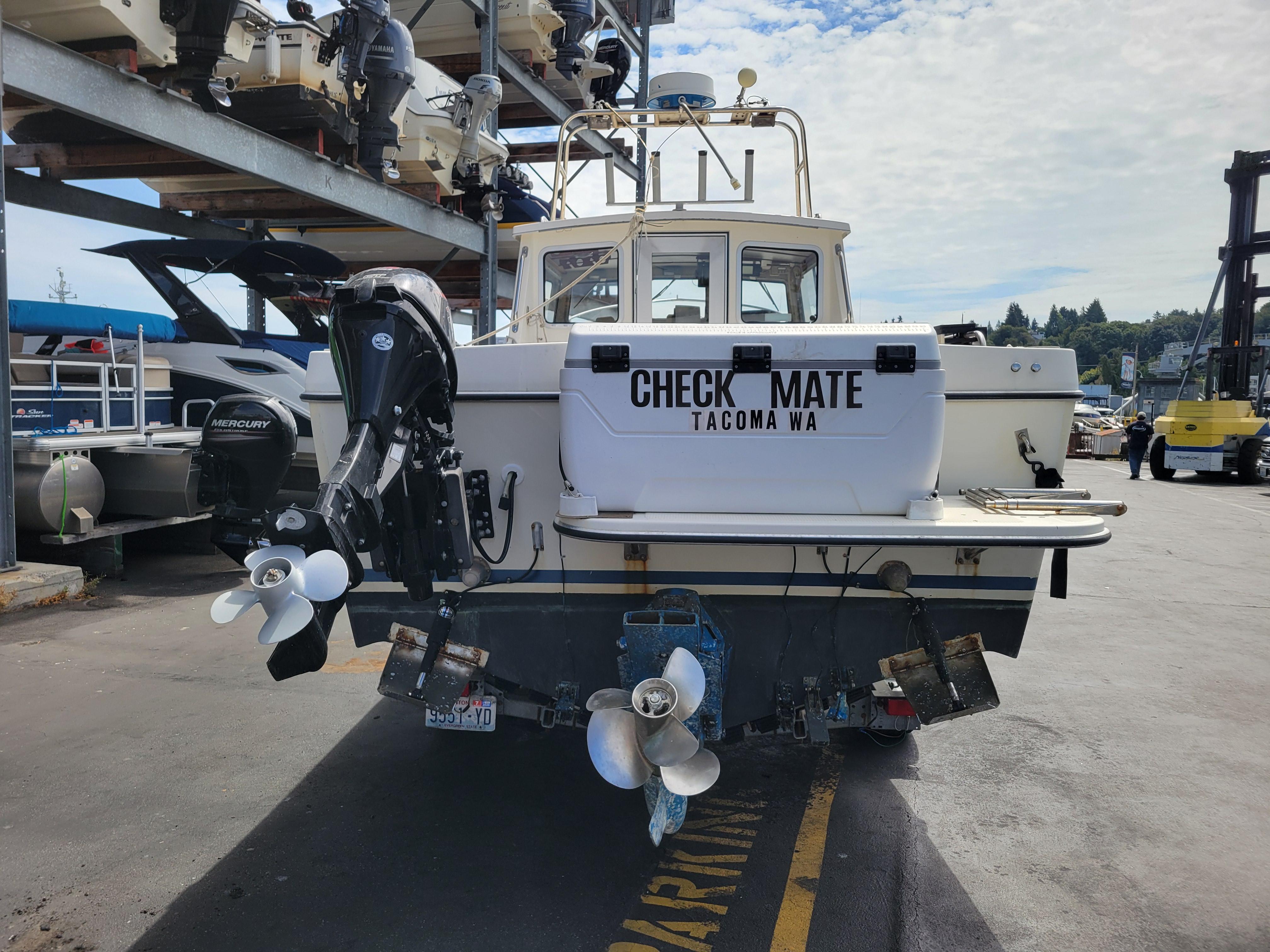 1999 SeaSport 2400 XL Limited boat at dock, featuring dual outboard motors.
