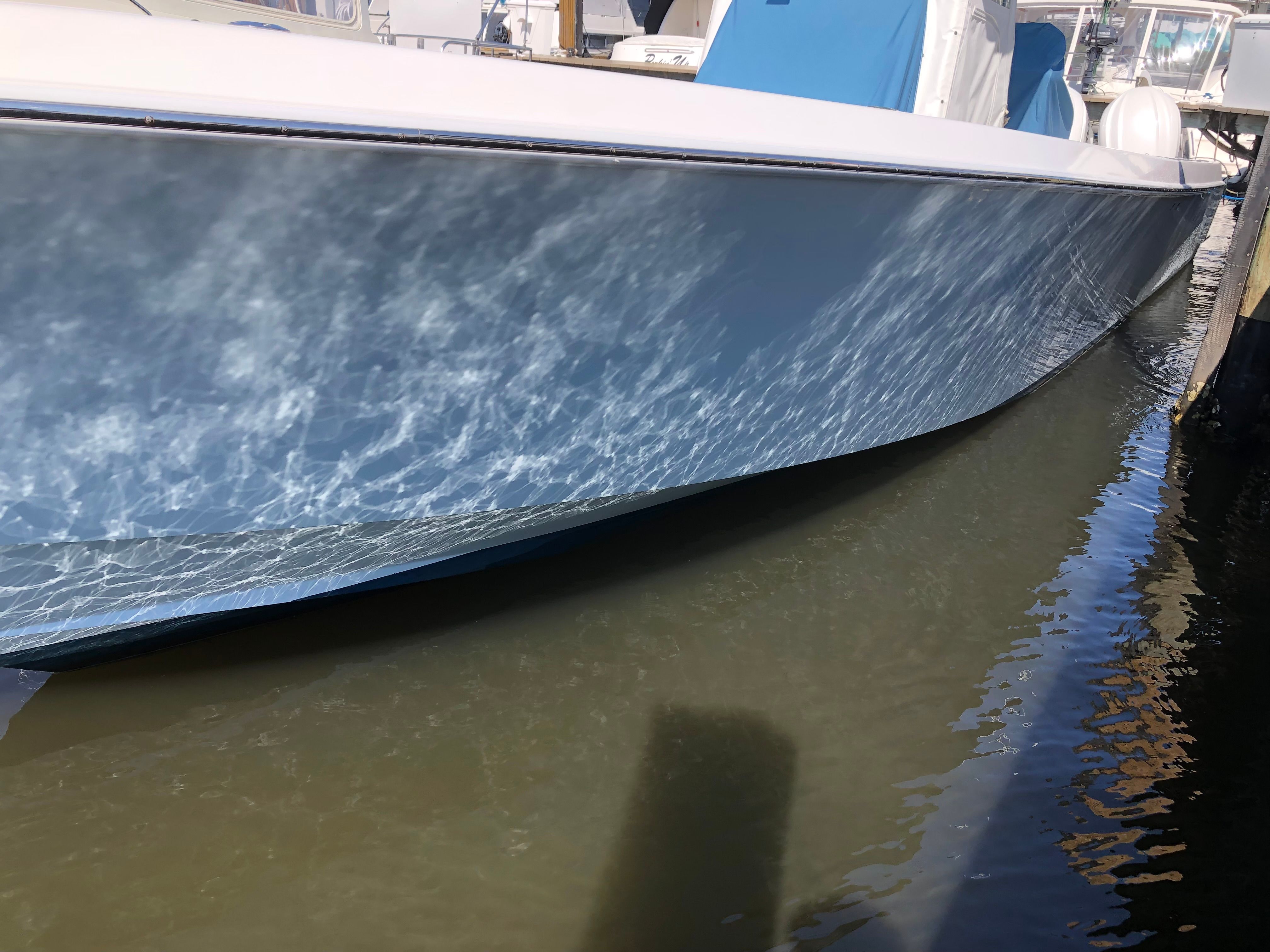 2009 Contender 33 Tournament boat in water, side view.