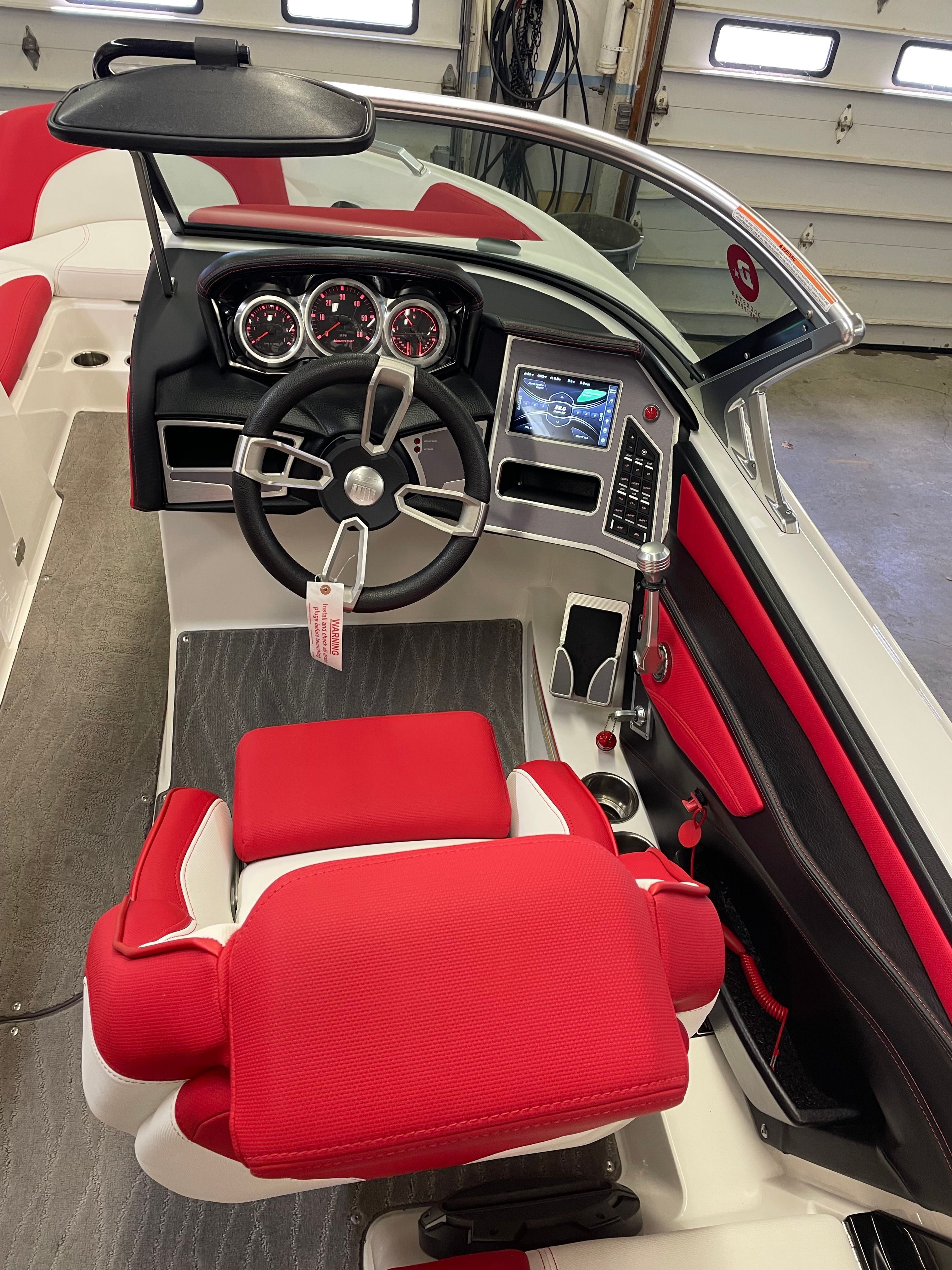 Interior of 2019 Master XT21 boat with red seat and dashboard.