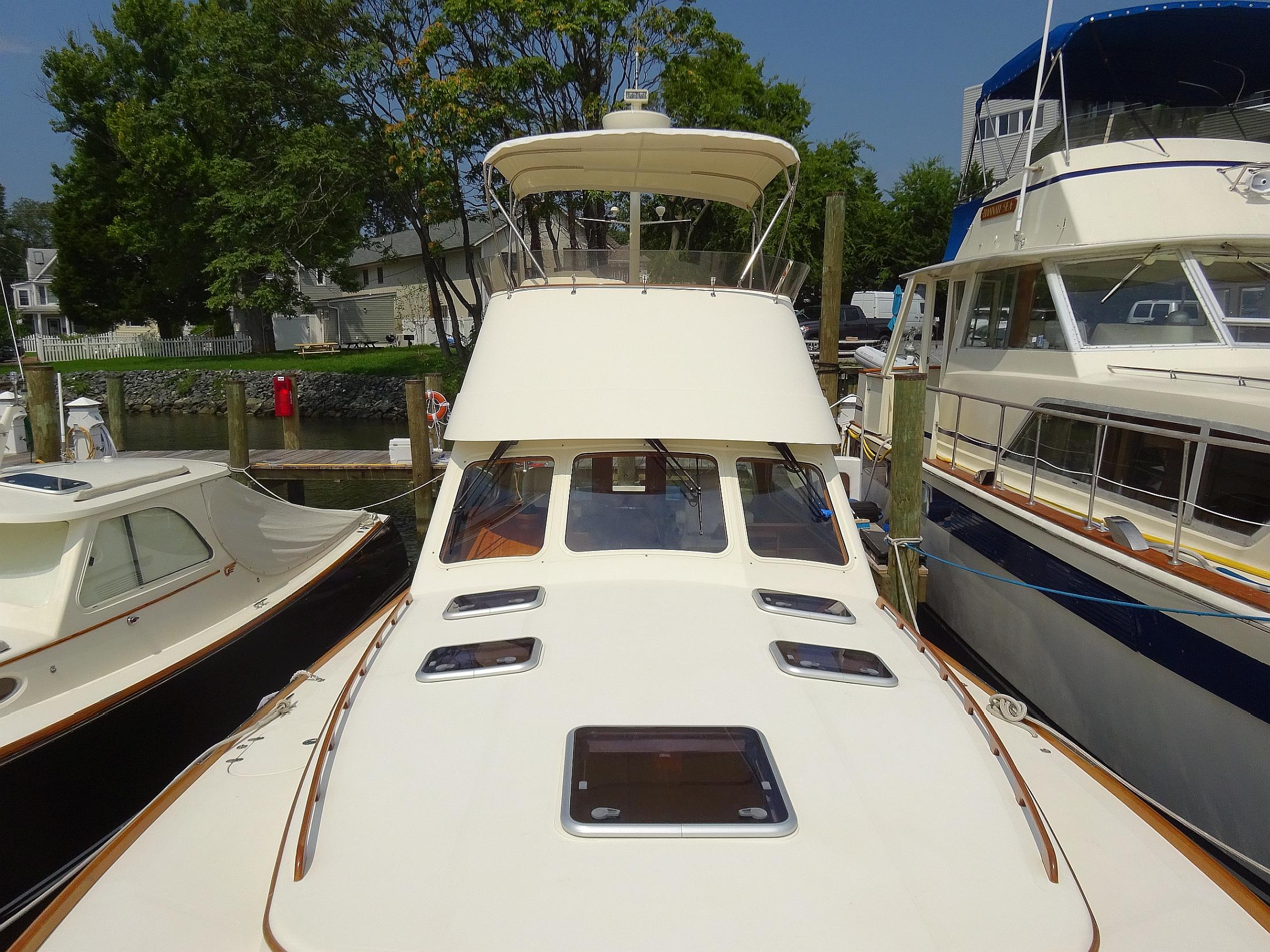 Hinckley Talaria 44 FB 2002 yacht docked, showcasing sleek design and spacious deck.