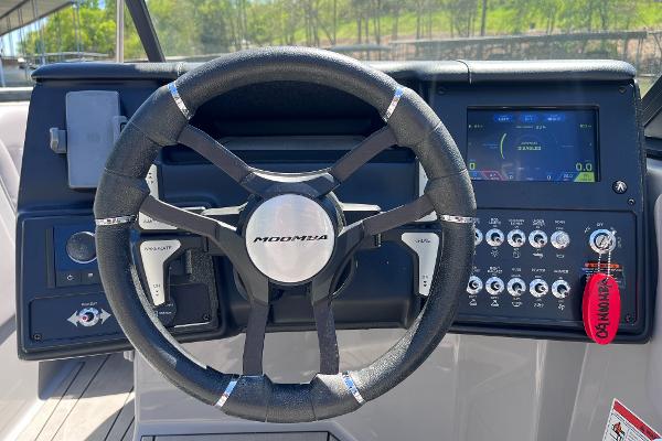 2024 Moomba Max boat dashboard with steering wheel and control panel.