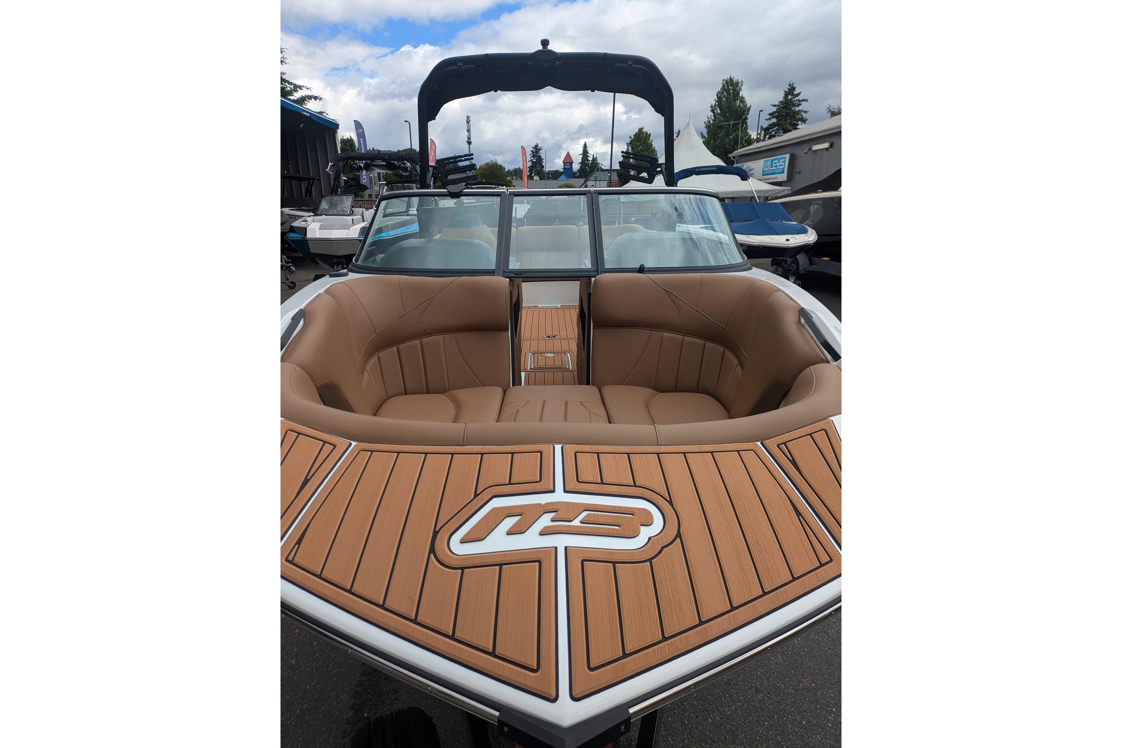 2026 MB B52-23 Classic LIMITED boat with tan seating and wood-style deck.