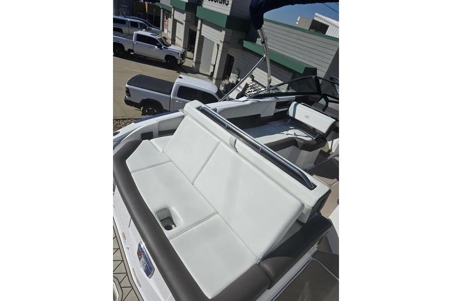 2022 Cobalt R4 boat with white seating and sleek design in a dealership setting.