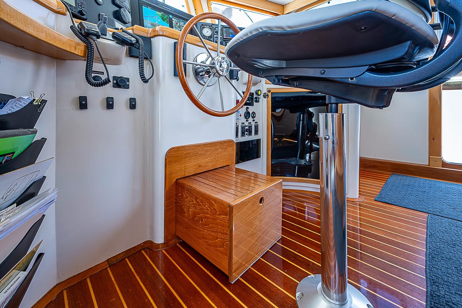Helm station of 2003 Magna Marine Nova Scotia 47 with wooden accents and modern controls.