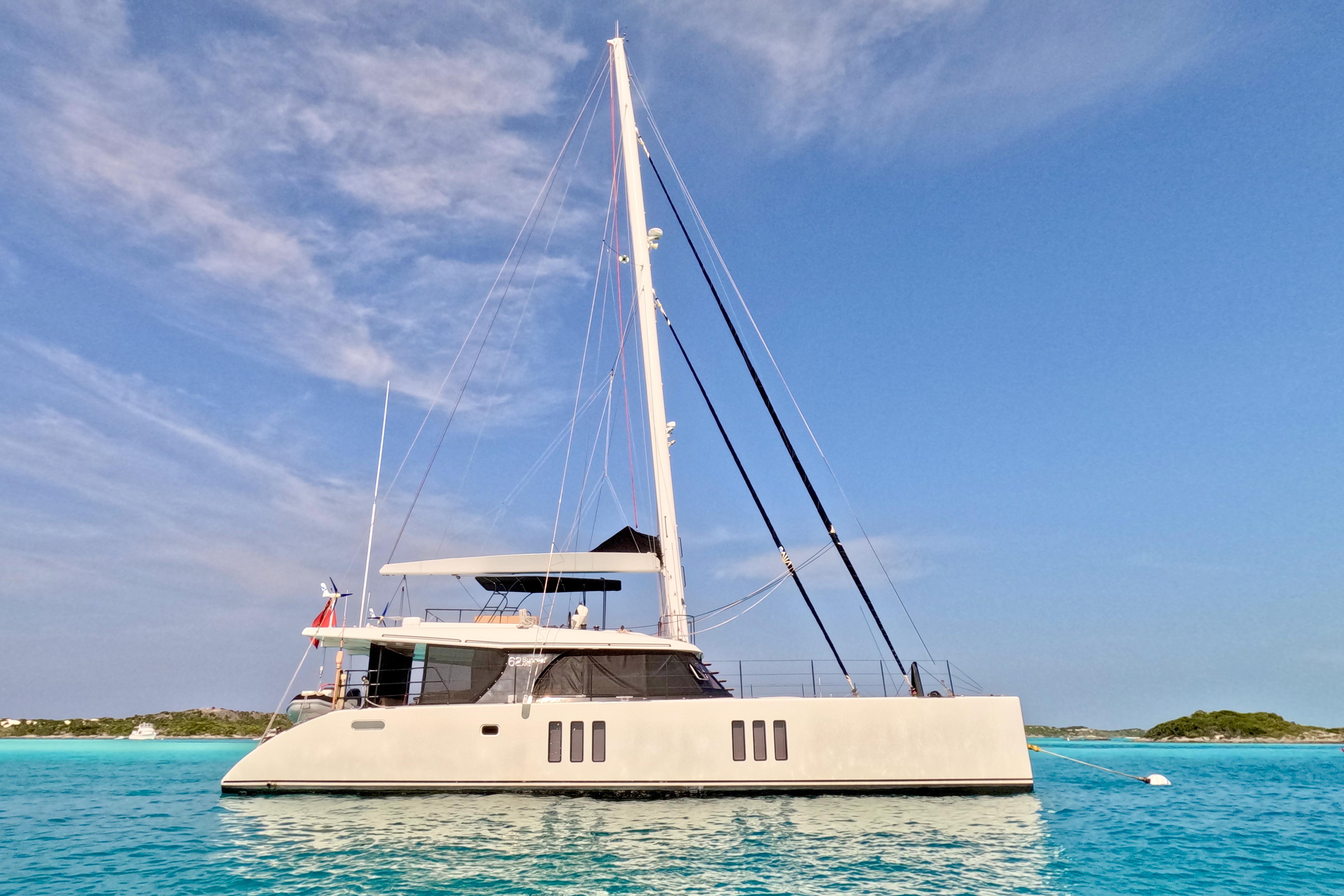 Luxurious 2018 Sunreef 62 ARC catamaran sailing on clear blue waters.