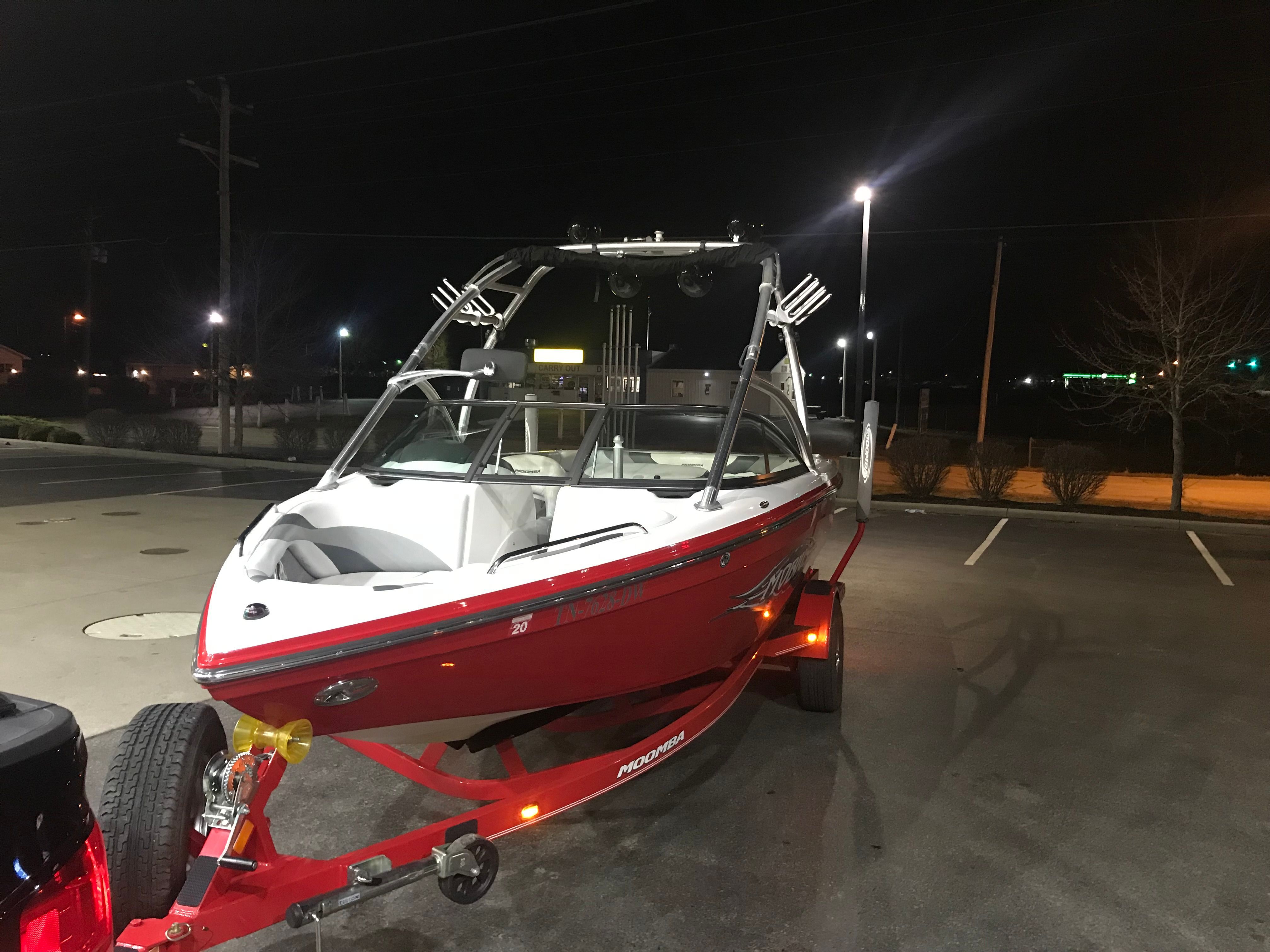 2008 Moomba Mobius LS boat on trailer at night.