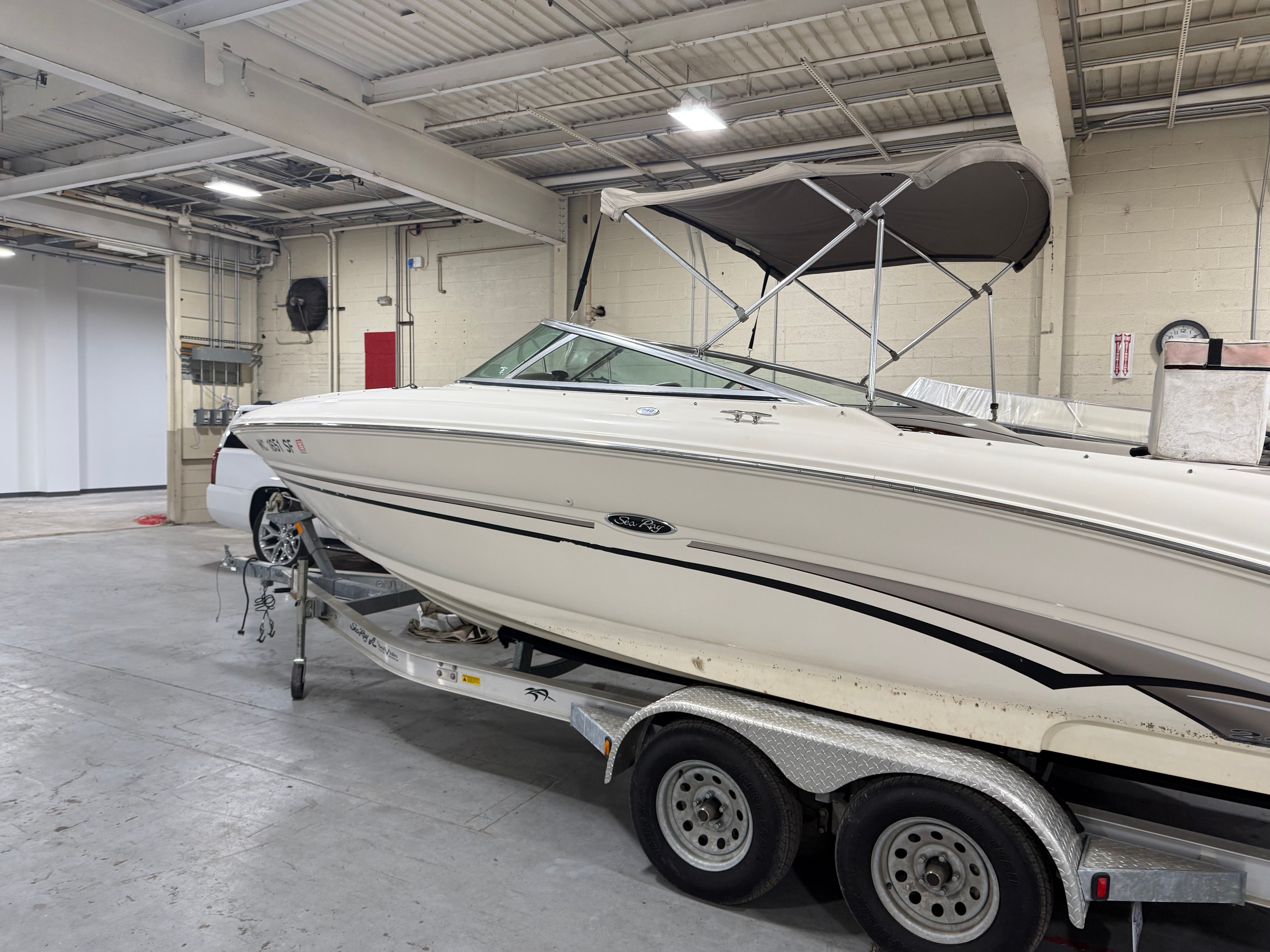 2003 Sea Ray 240 SIGNATURE boat on trailer in warehouse.
